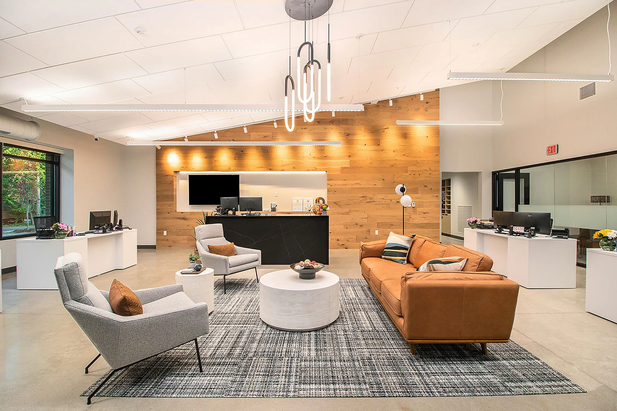 Modern lobby with chic furnishings, featuring a cozy seating area, contemporary lighting, and stylish decor.