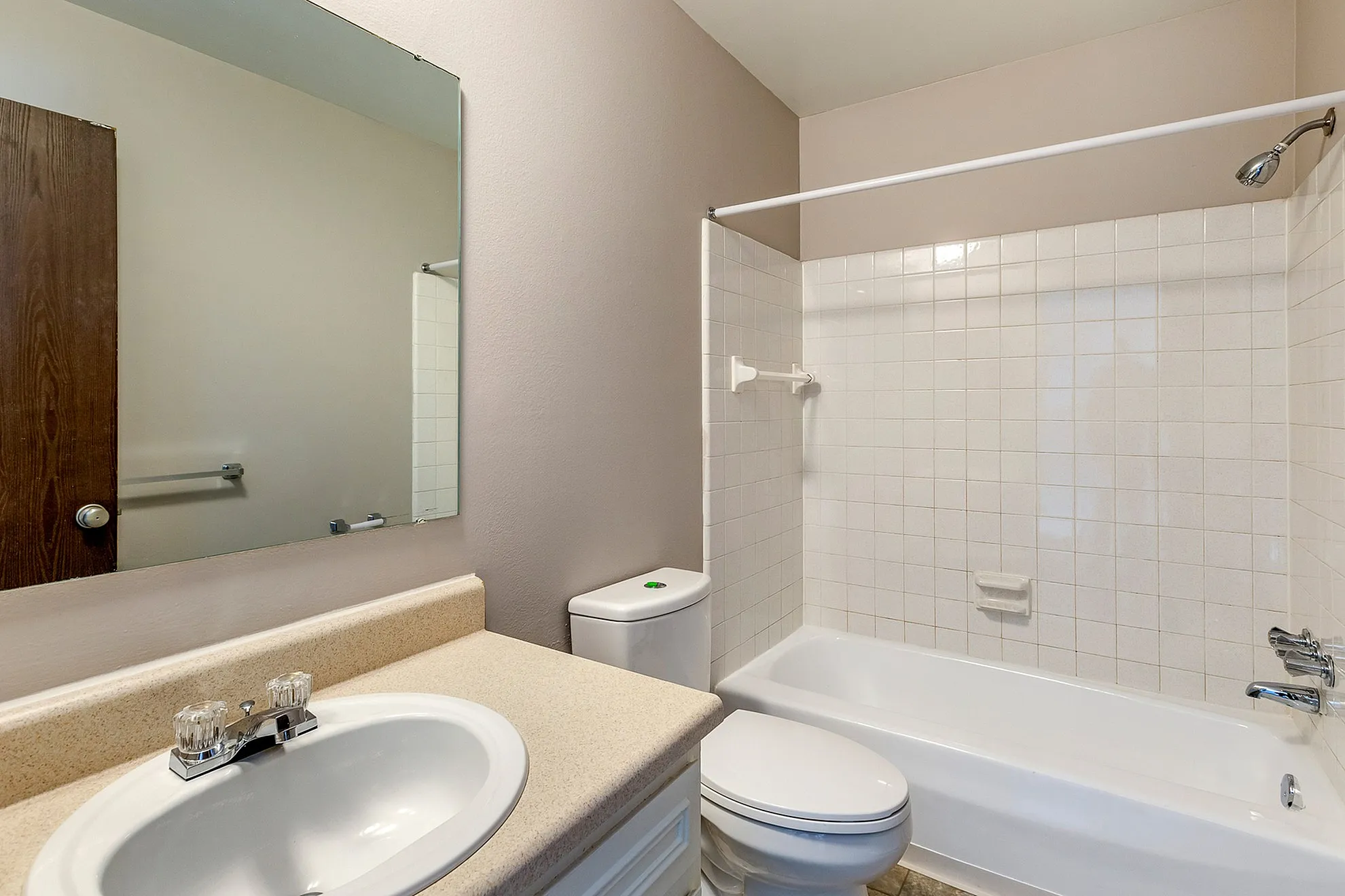 Bright and inviting bathroom featuring a modern vanity, tub-shower combo, and sleek fixtures.