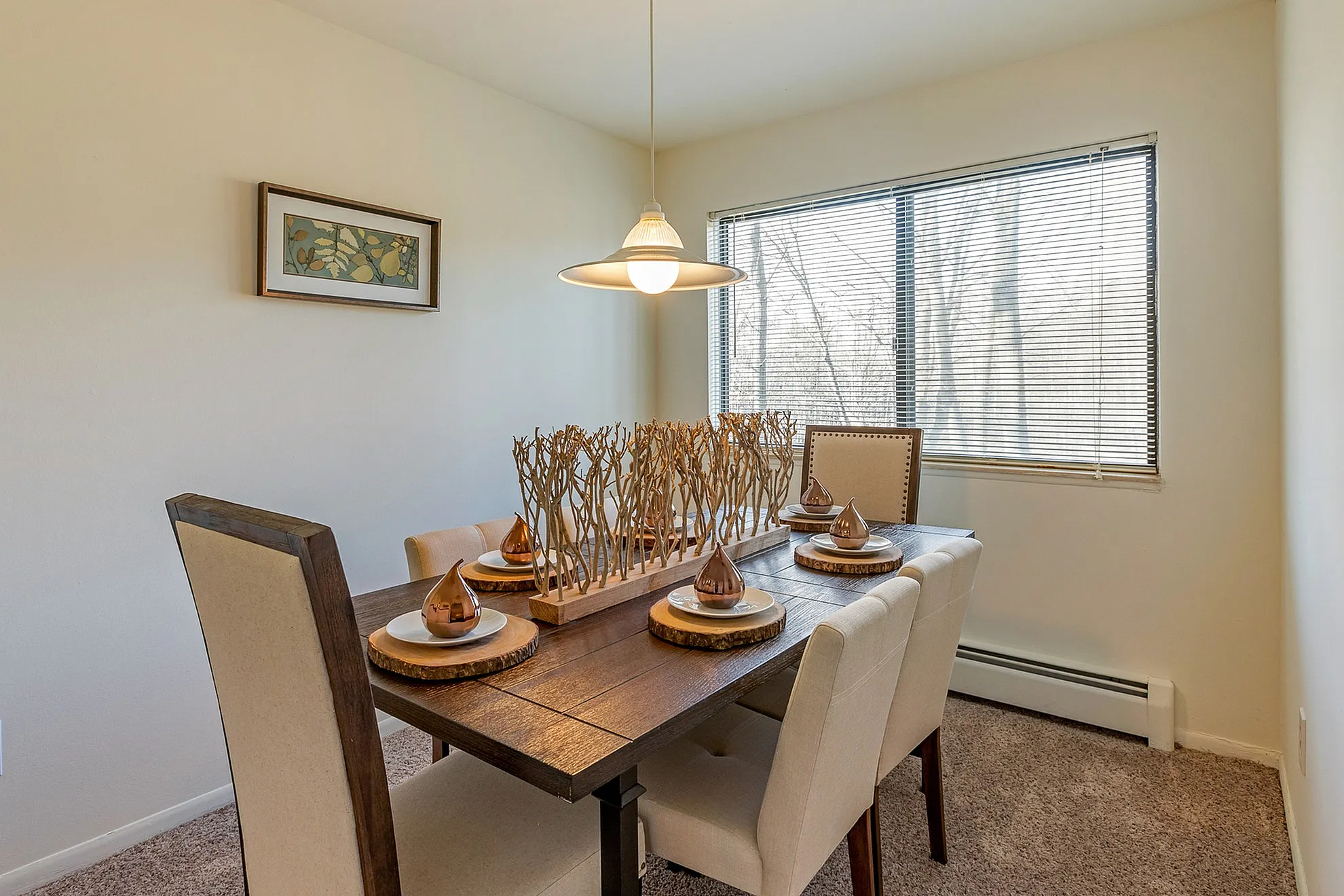 Chic dining room with elegant wood table, modern decor, and ambient lighting, offering a serene and stylish dining experience.
