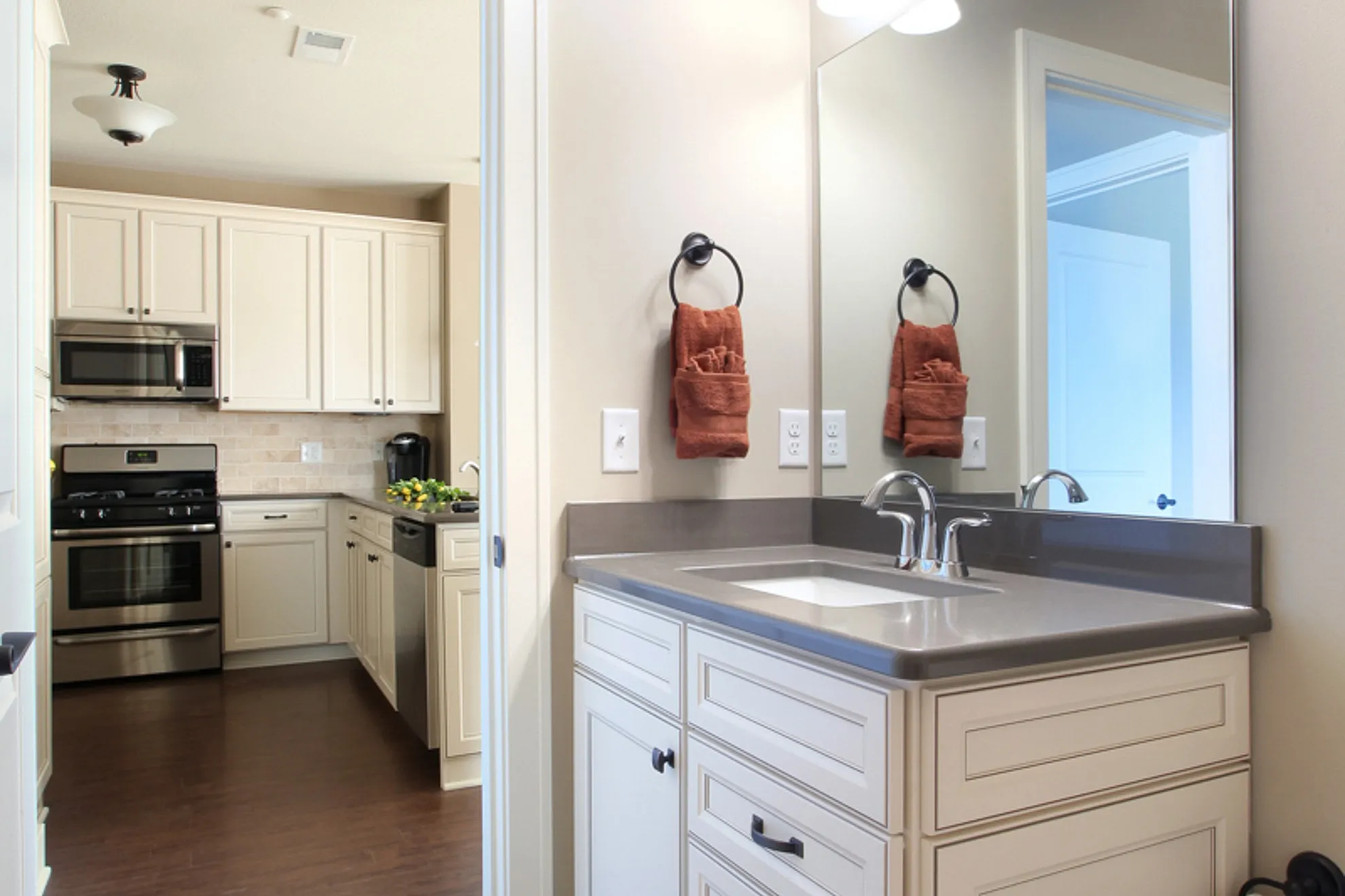 Contemporary kitchen and bathroom with sleek cabinetry, modern appliances, and an elegant mirror, combined in a cozy apartment setting.
