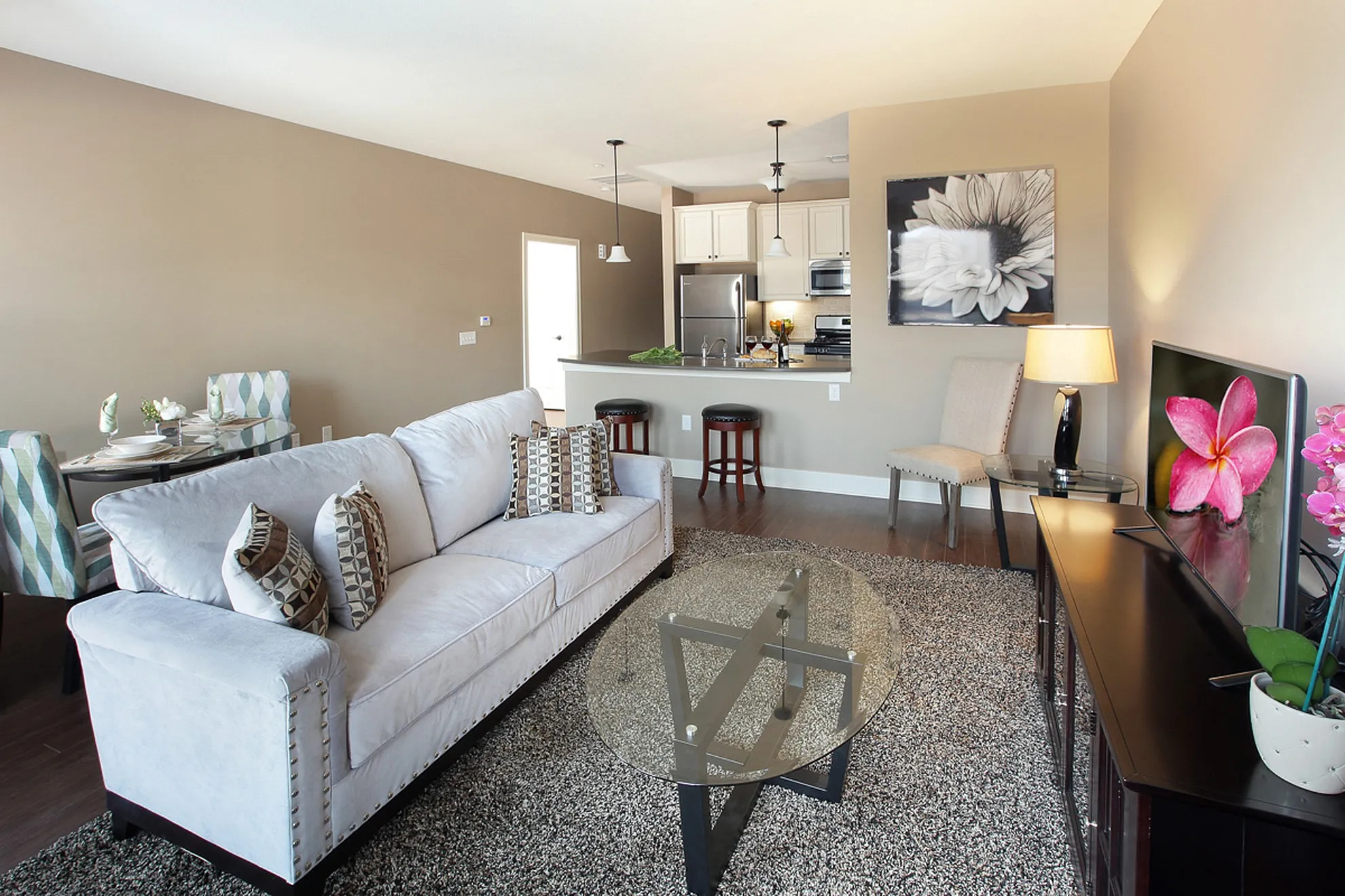 Inviting open-concept living space with cozy seating, contemporary decor, and modern kitchen, ideal for relaxation and entertaining.
