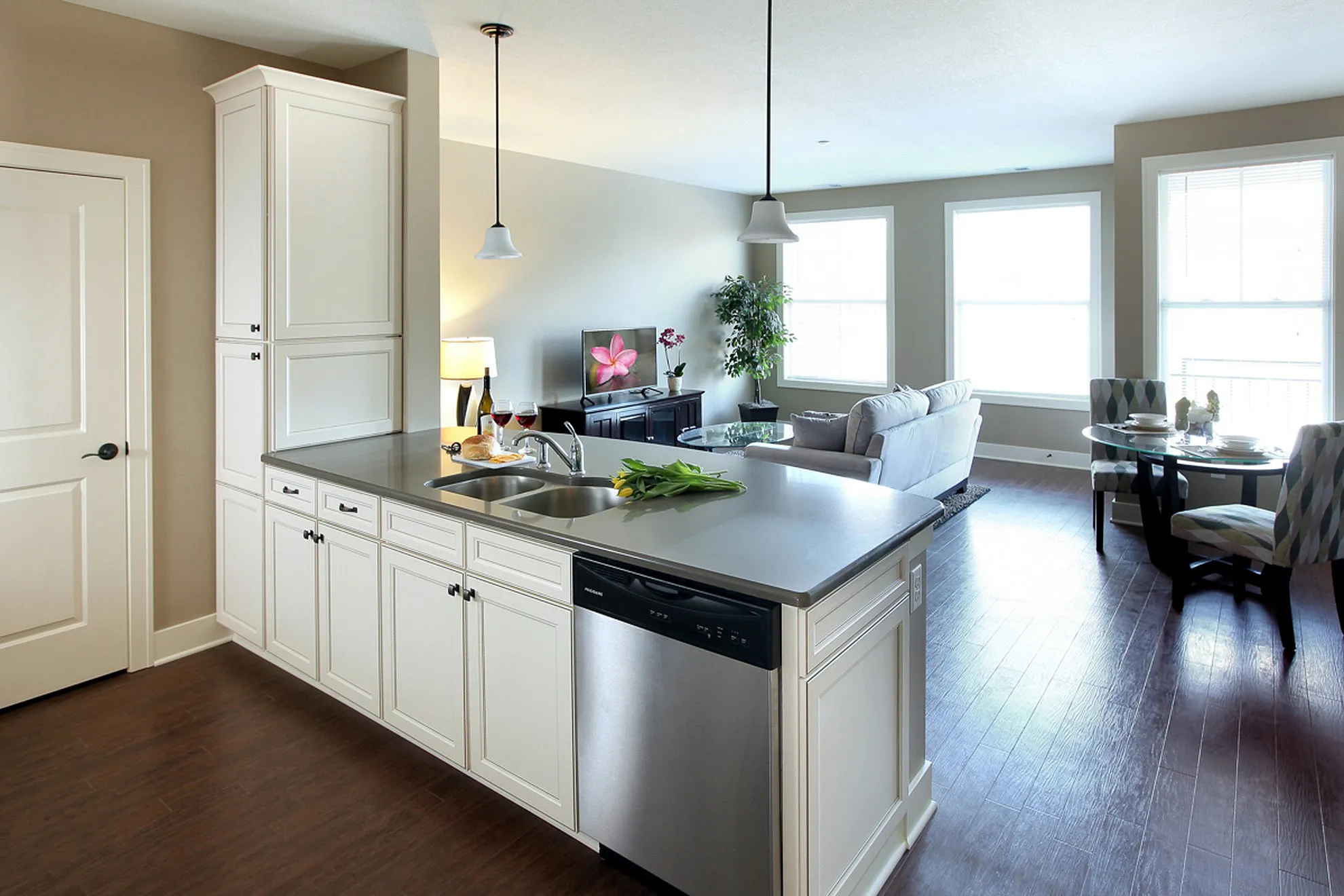 Bright and inviting open-concept kitchen and living area with modern cabinetry, sleek countertops, and airy dining space.