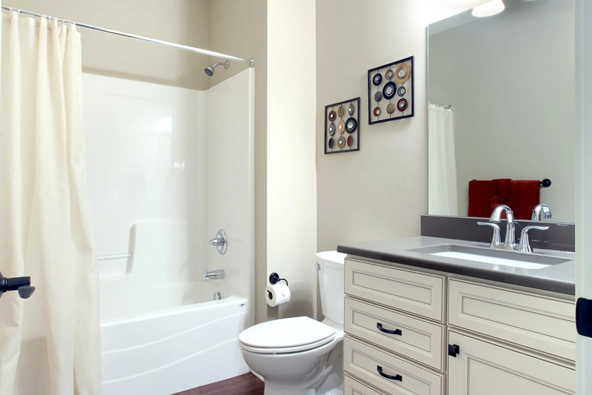 Modern bathroom featuring sleek fixtures, a spacious vanity with elegant cabinetry, and a pristine shower area.