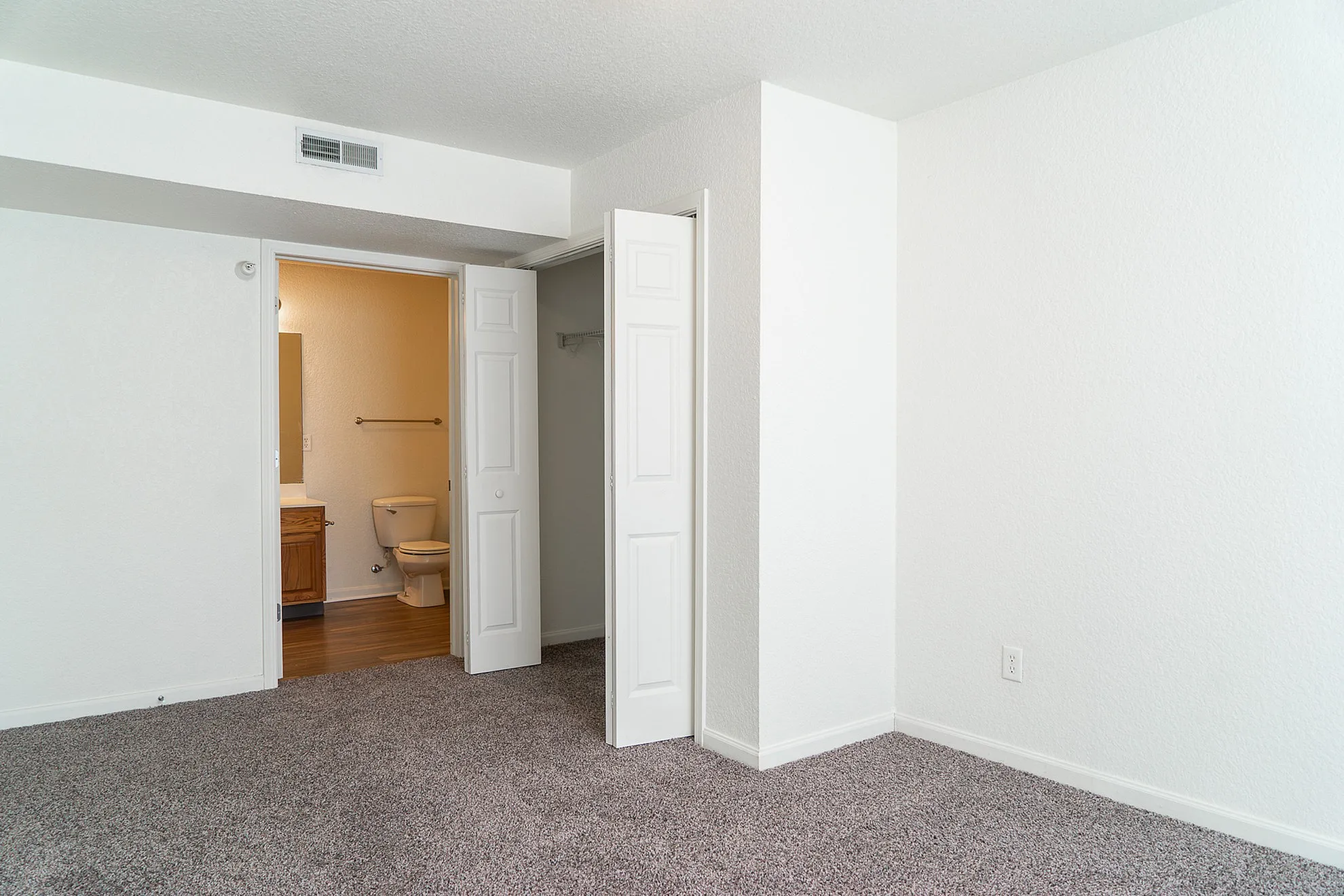 Bright and spacious bedroom with plush carpet and convenient ensuite bathroom.