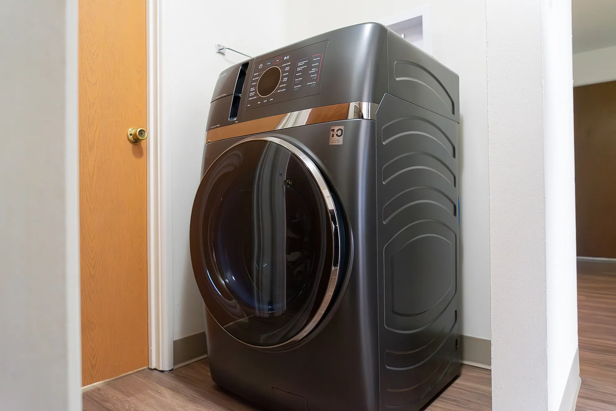 Sleek modern laundry space featuring a high-efficiency washer with a glossy finish, perfect for contemporary apartments.