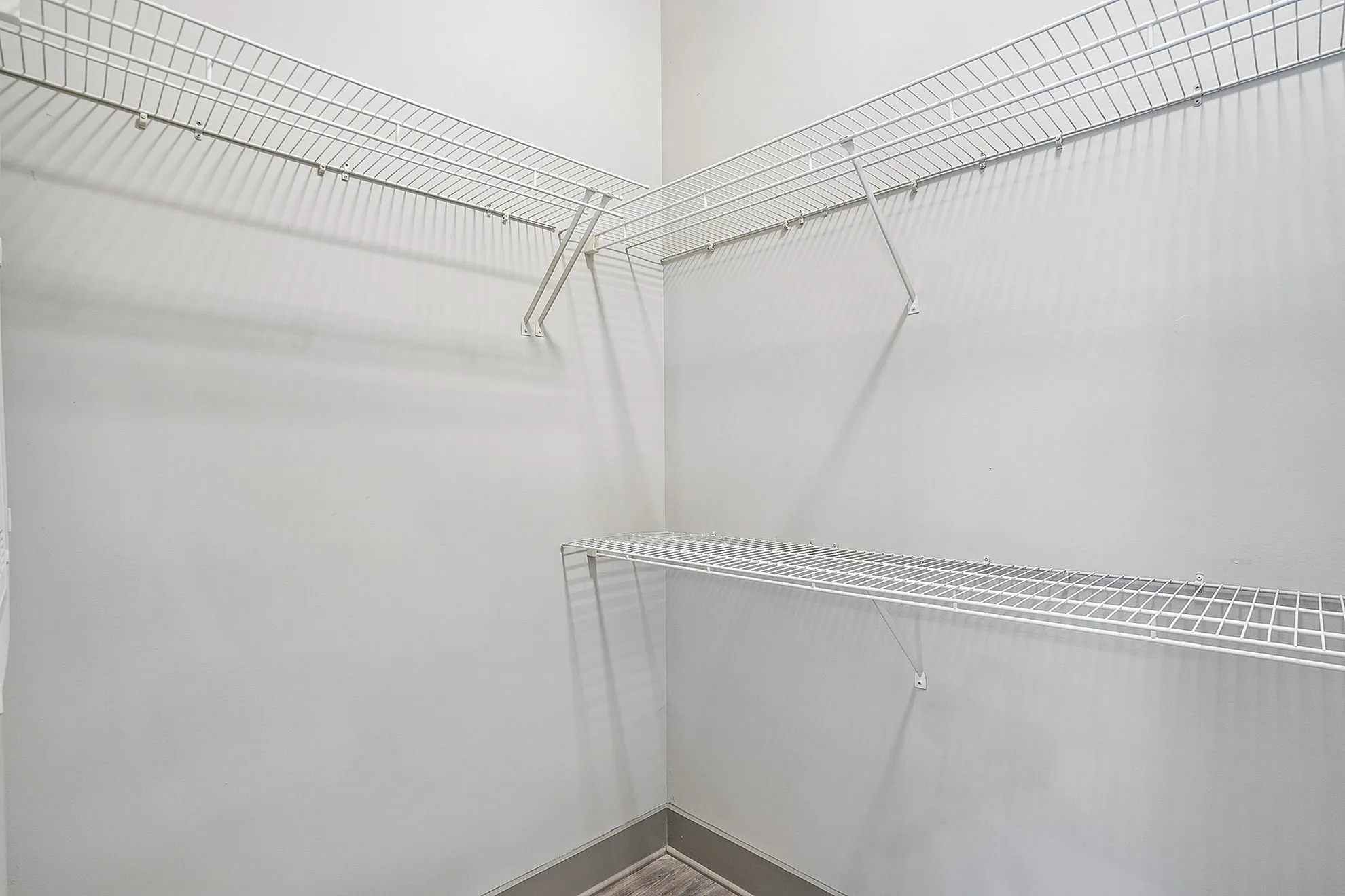 Spacious walk-in closet with sleek wire shelving for optimal organization.