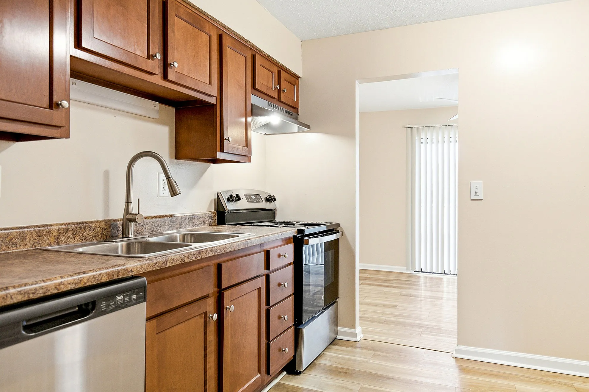 Modern kitchen with sleek wooden cabinetry, stainless steel appliances, and a bright, open layout.