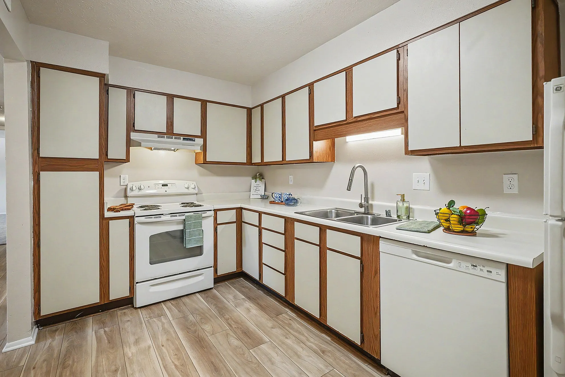Inviting kitchen with chic wooden cabinetry, sleek countertops, and modern appliances perfect for culinary adventures.
