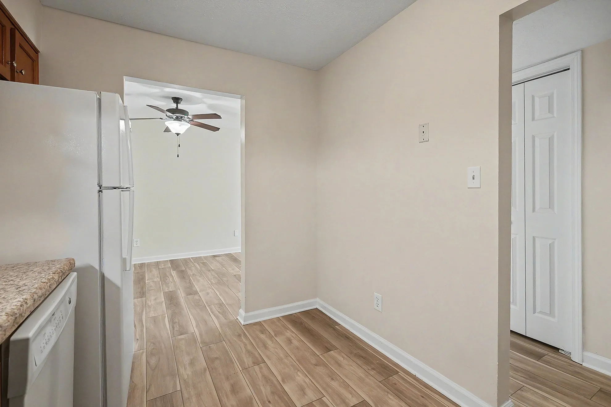 Bright and welcoming kitchen with sleek tile flooring, modern appliances, and an adjacent dining area.
