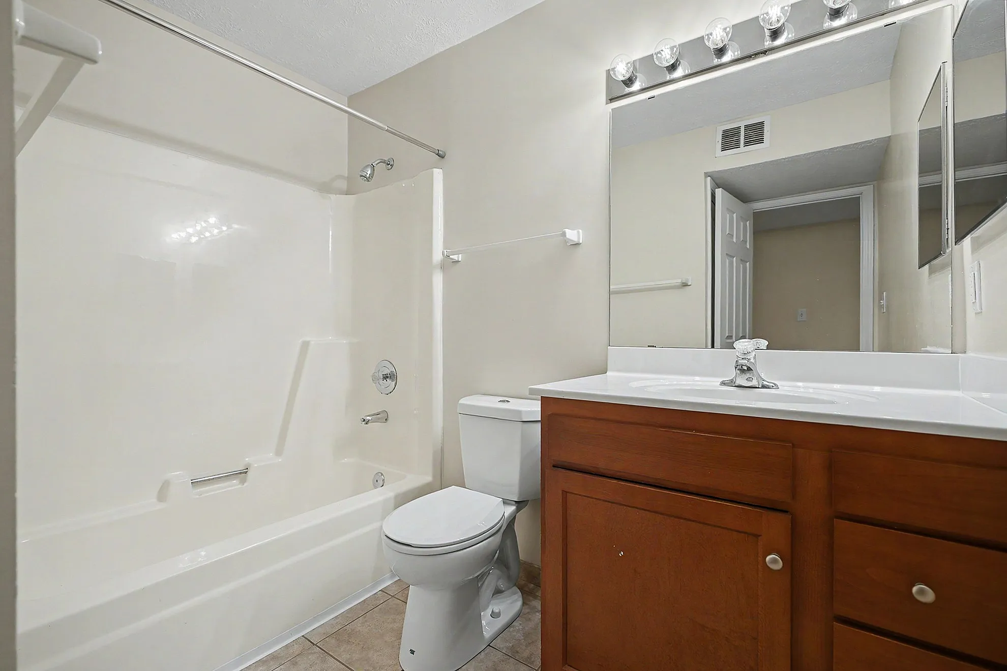 Modern bathroom with elegant under-sink storage, sleek fixtures, and a polished mirror.