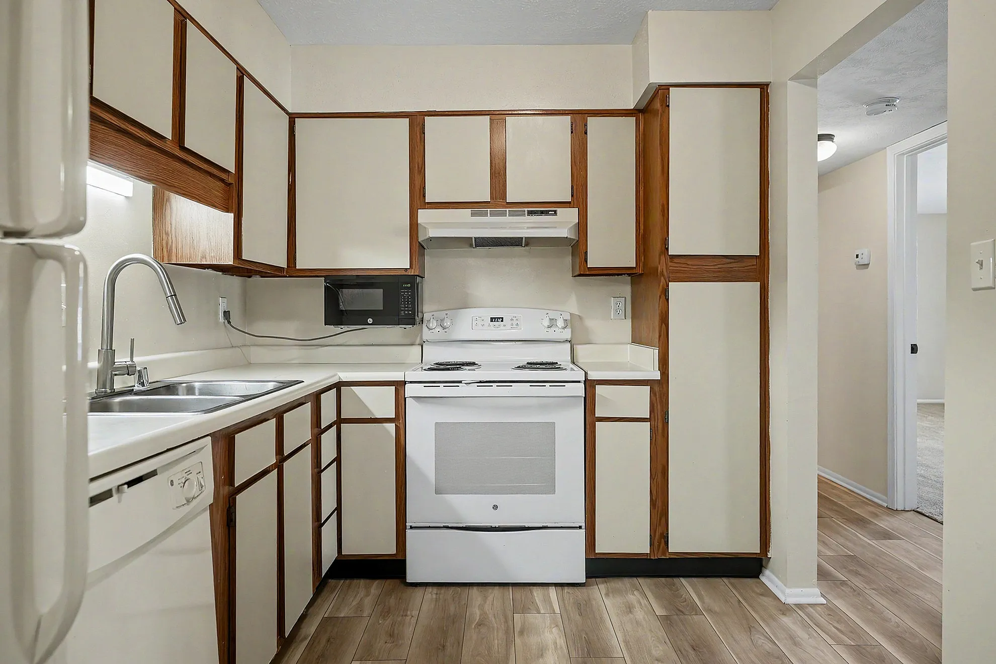 Charming kitchen with modern appliances, abundant cabinetry, and sleek countertops, perfect for culinary adventures.