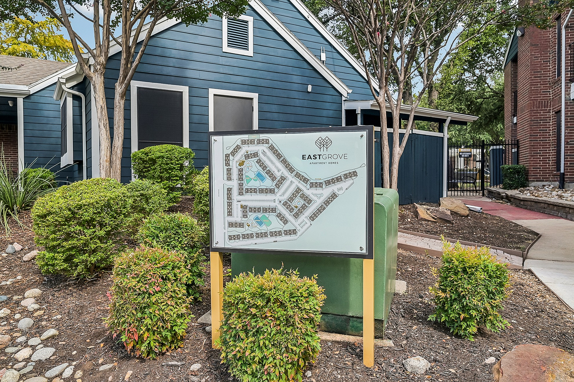 Charming view of Eastgrove Apartment Homes showcasing a detailed community map amidst lush greenery, inviting you to explore the tranquil neighborhood.