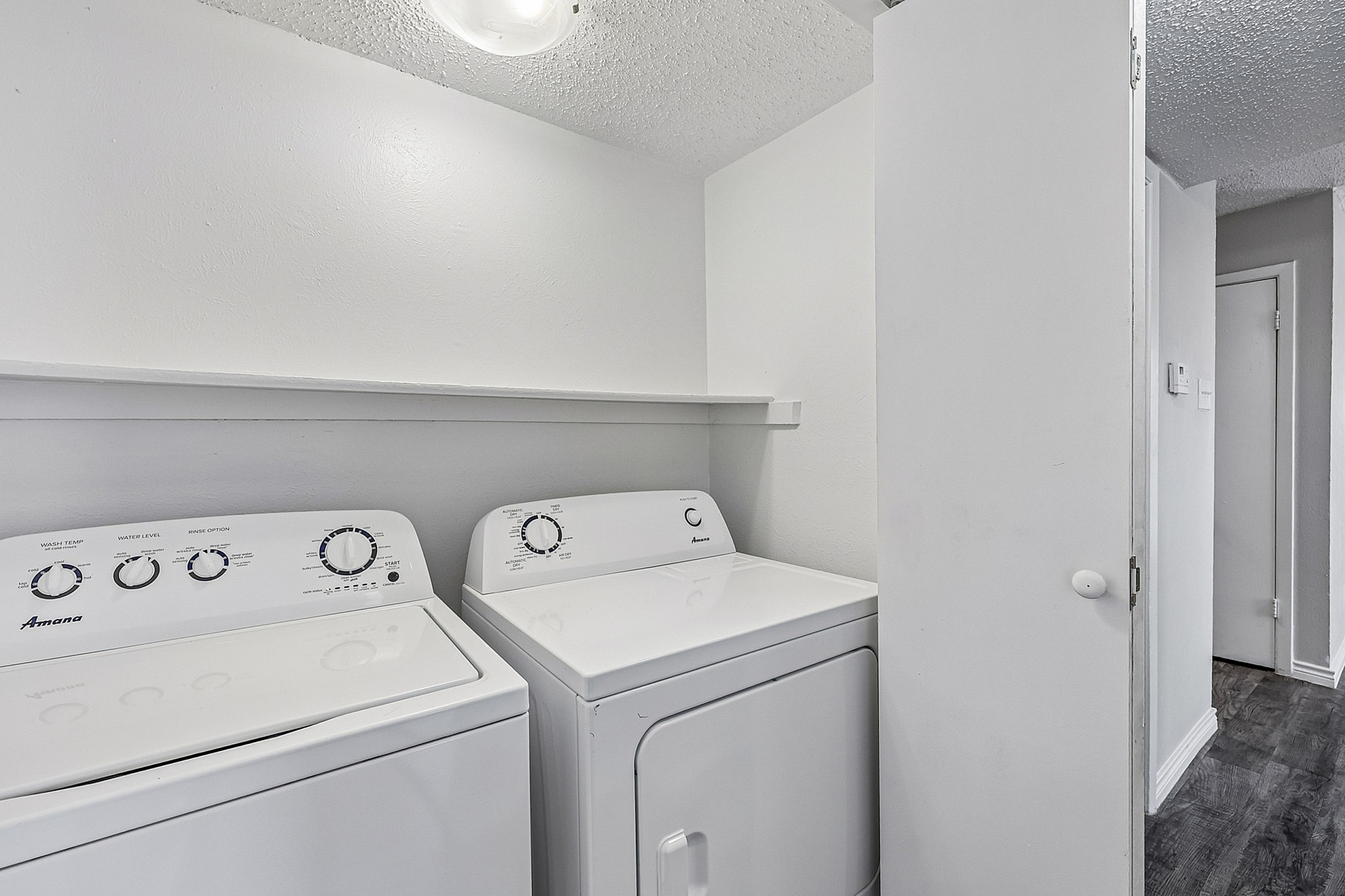 Sleek in-unit laundry area with modern washer and dryer, adding convenience and efficiency to apartment living.