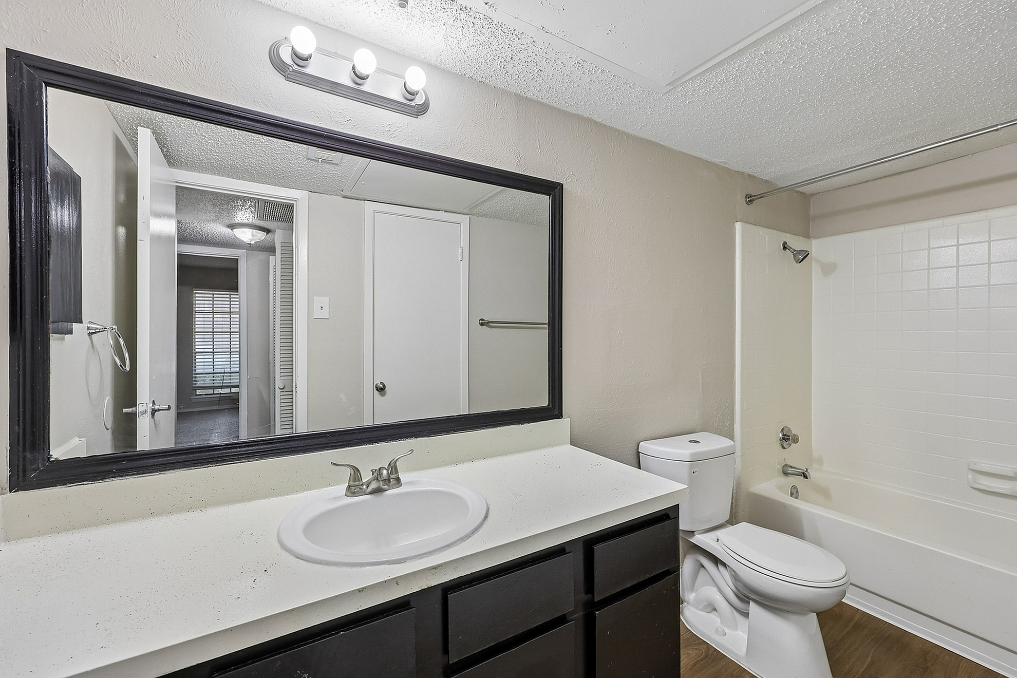 Modern bathroom with sleek fixtures, large mirror, and cozy ambiance, perfect for relaxation.