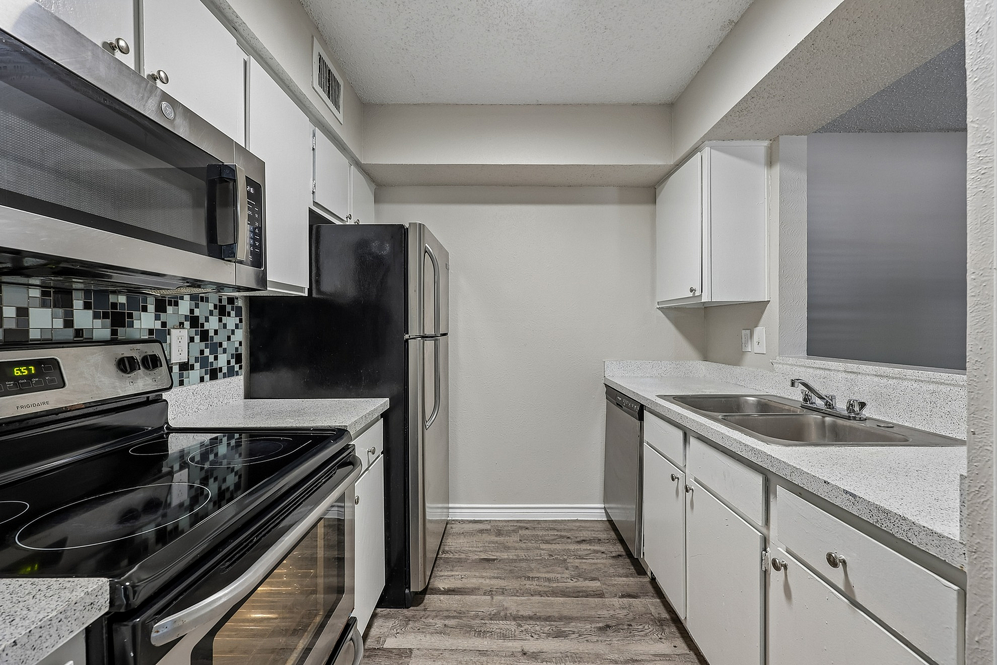 Modern kitchen with sleek stainless steel appliances, elegant countertops, and stylish cabinetry, perfect for culinary enthusiasts.