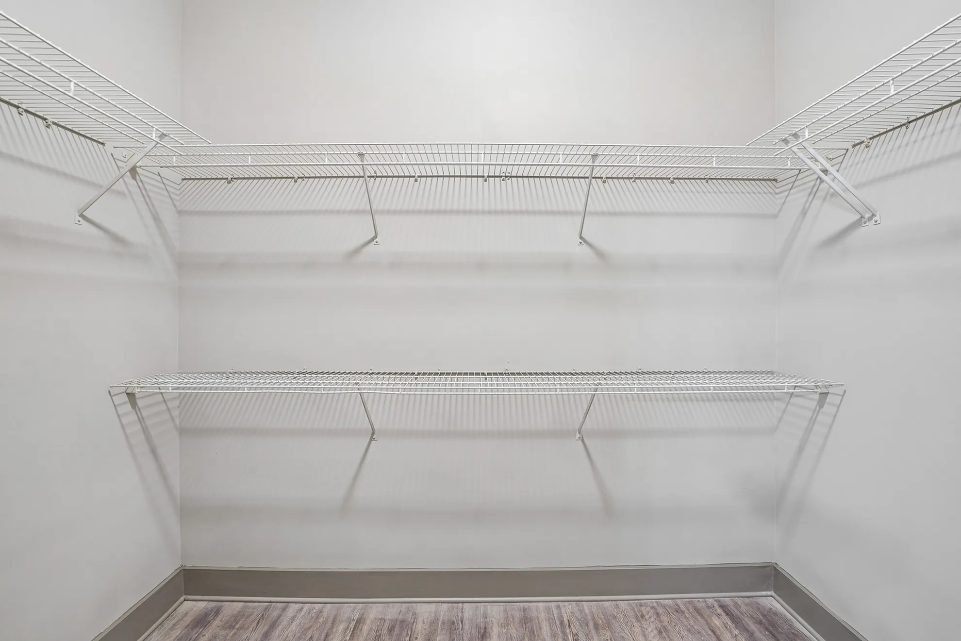 Spacious walk-in closet with ample shelving and modern design for optimal organization.