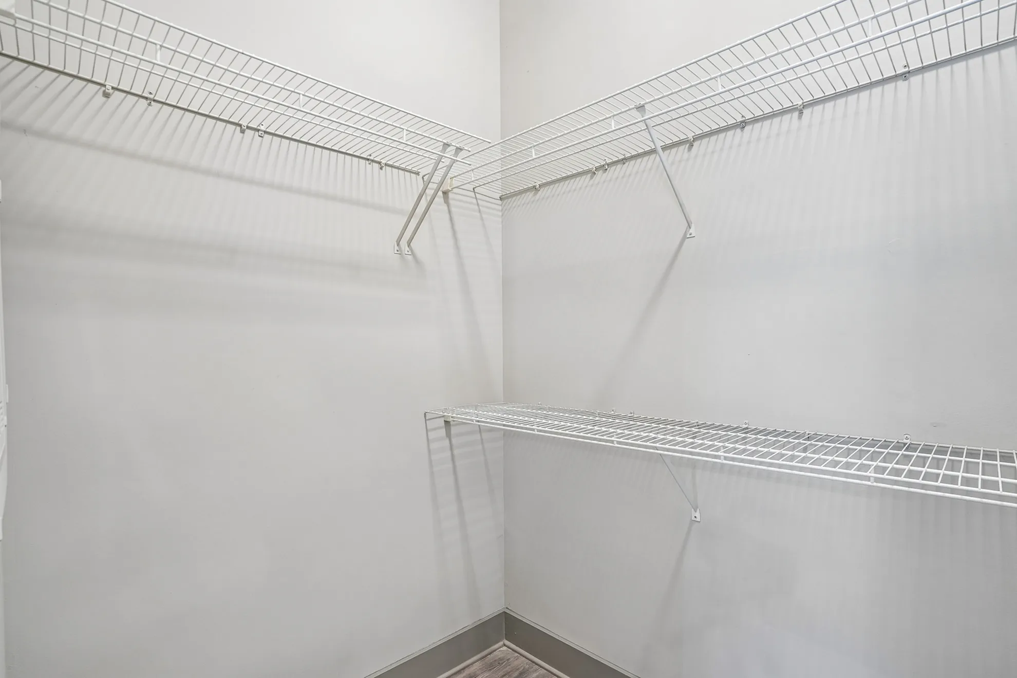 Spacious walk-in closet with ample wire shelving for organized storage and modern design.