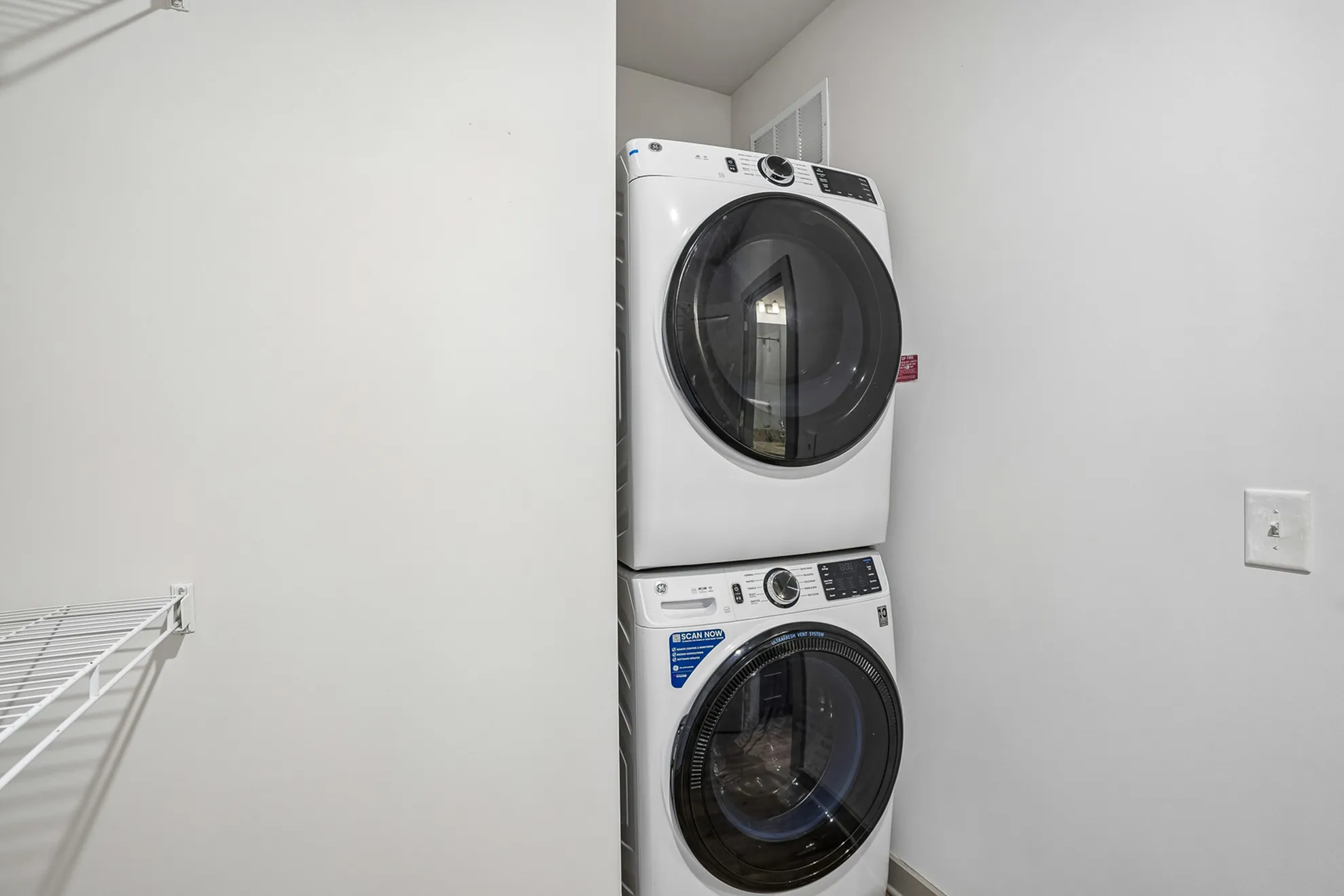 Modern laundry closet with a convenient stackable washer and dryer, perfect for efficient apartment living.