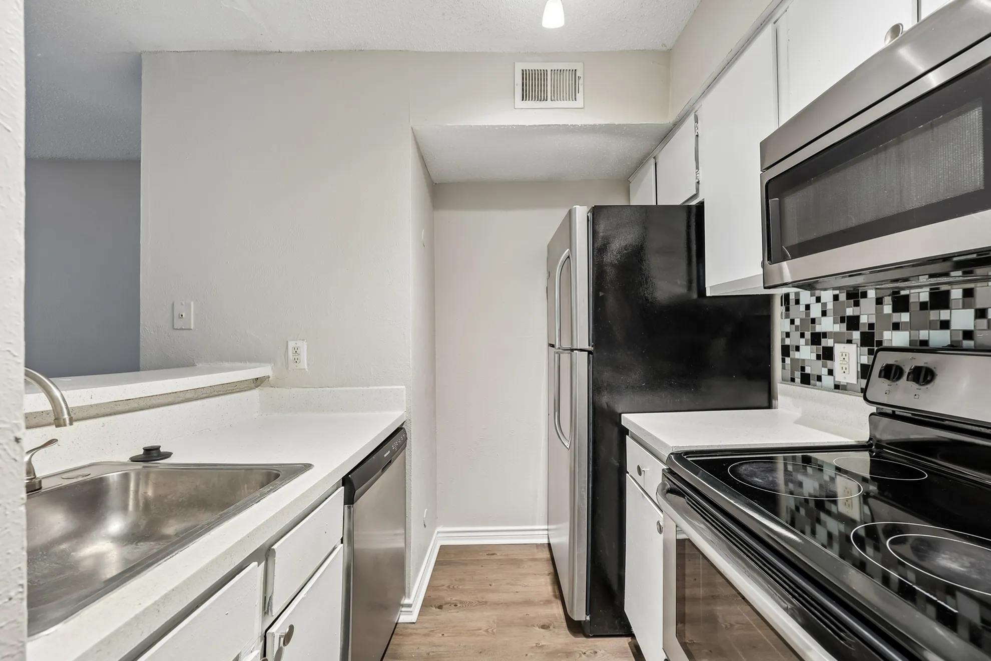 Contemporary kitchen featuring sleek stainless steel appliances, modern cabinetry, and stylish backsplash with ample counter space.