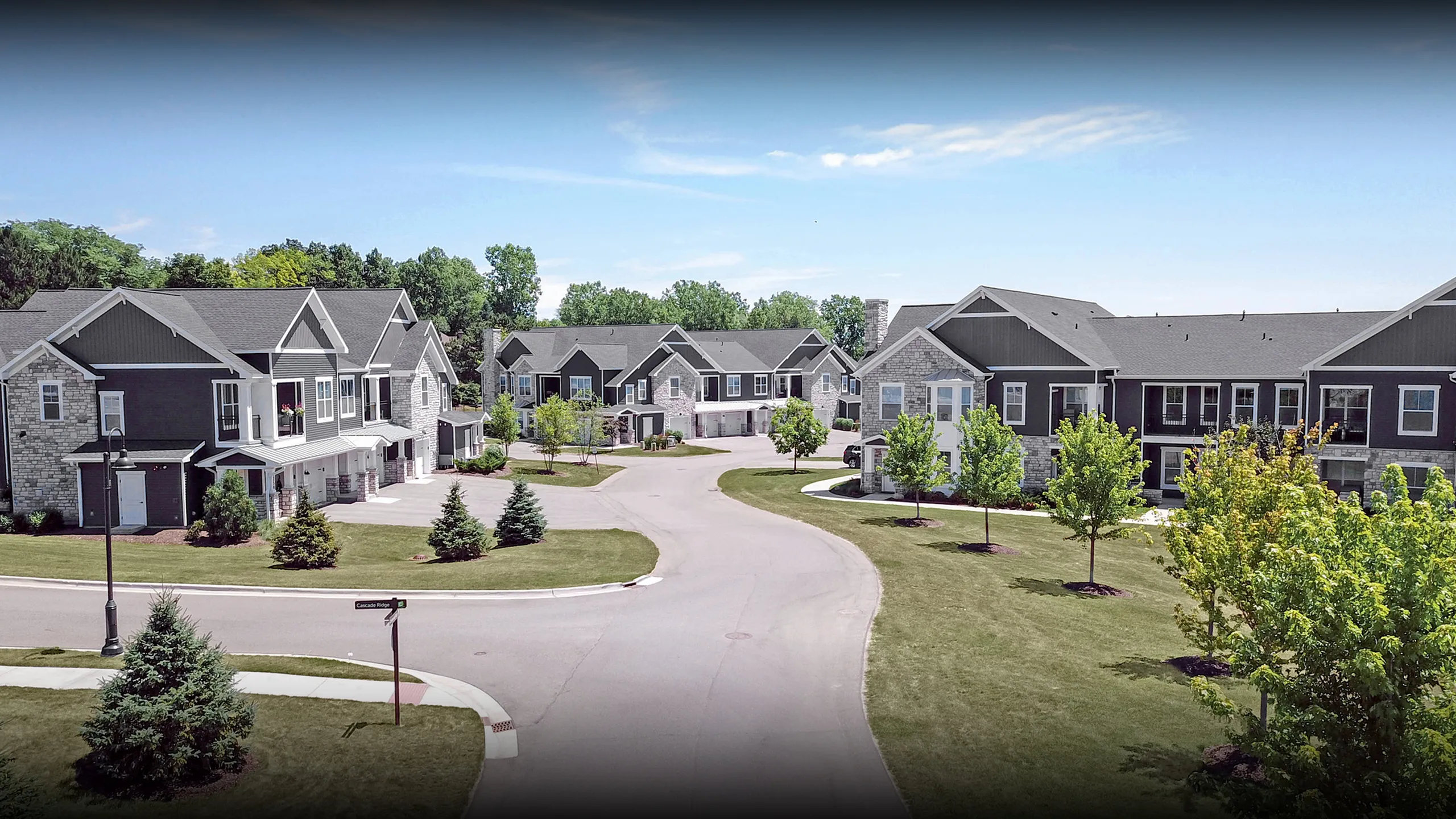 Charming suburban apartment complex with modern architecture, surrounded by lush greenery and a peaceful neighborhood setting.
