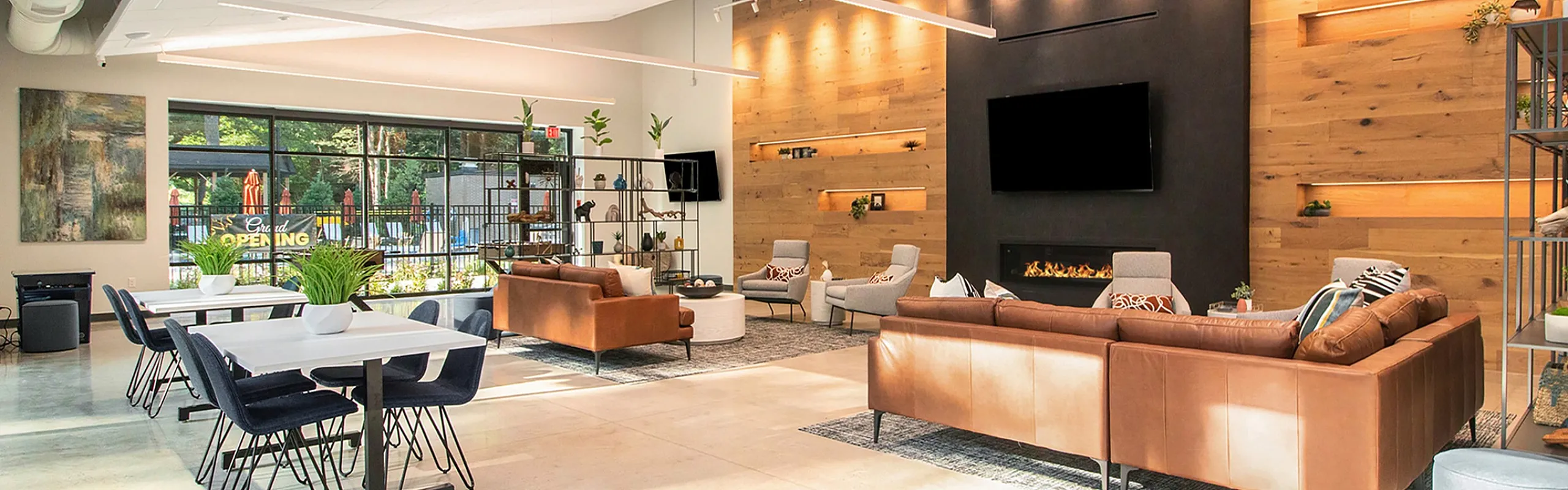 Spacious modern lounge with elegant leather sofas, ambient lighting, and a cozy fireplace, ideal for relaxation and social gatherings.
