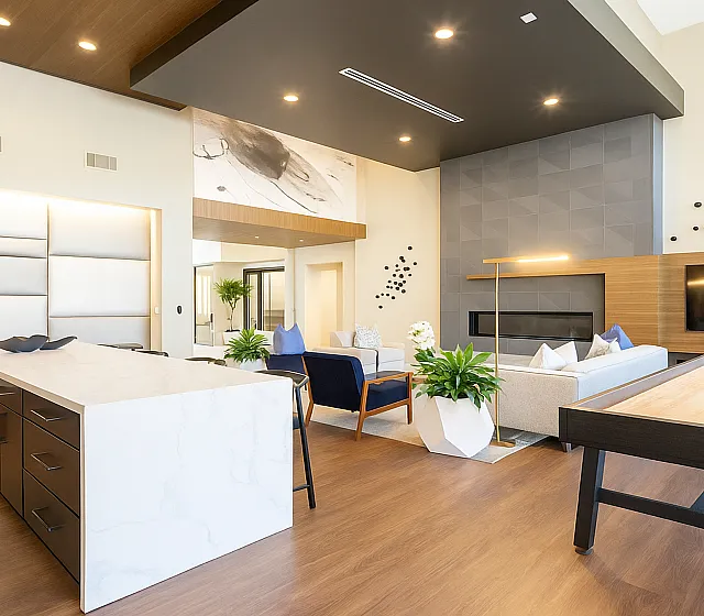 Elegant modern living area featuring sleek furniture, a large flat-screen TV, and a stylish island kitchen with luxurious finishes.