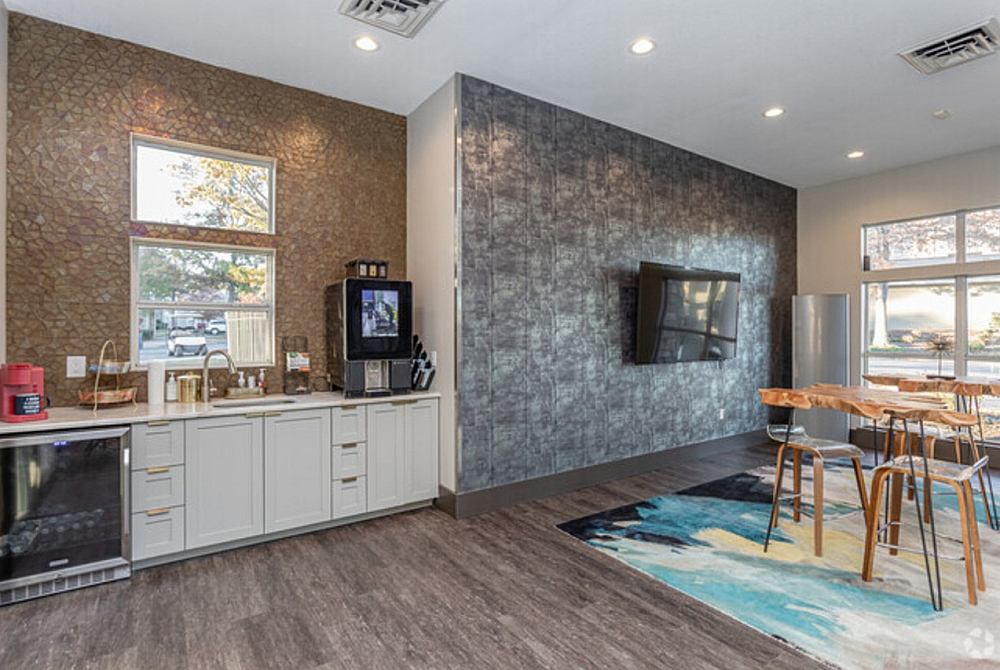 Modern kitchen and dining area with sleek appliances, stylish cabinetry, and a cozy seating space, ideal for entertaining.