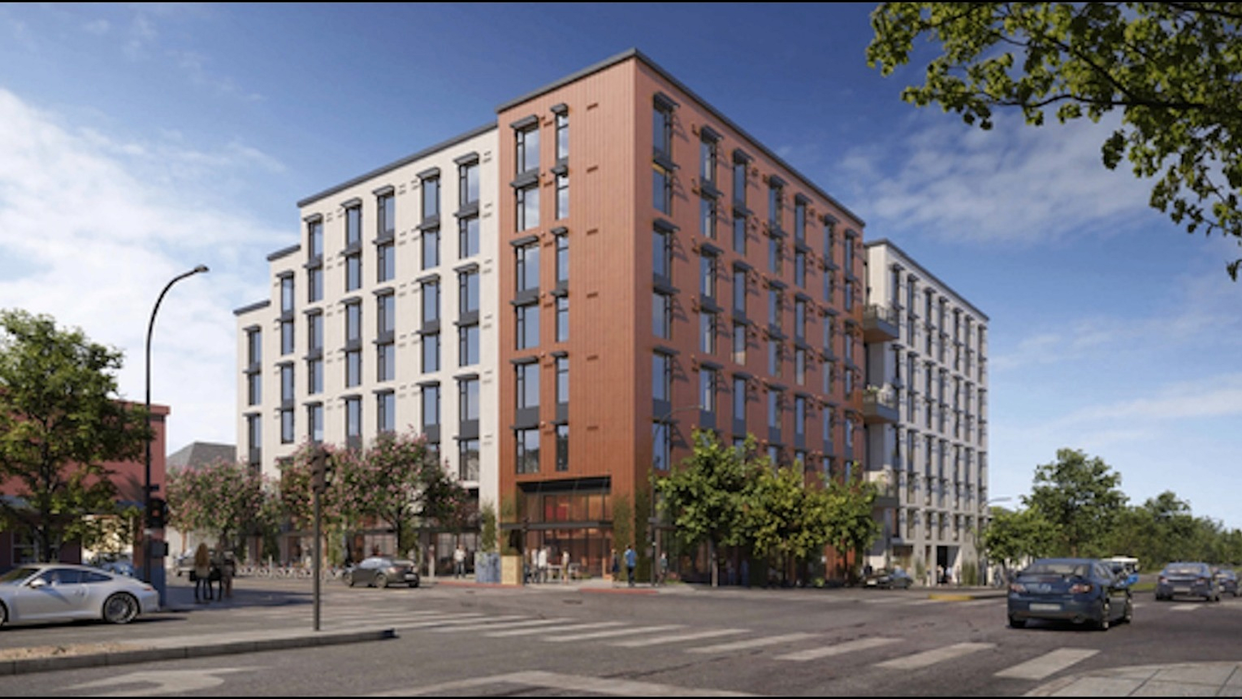 Modern urban apartment building with sleek architectural design, large windows, and vibrant street view.