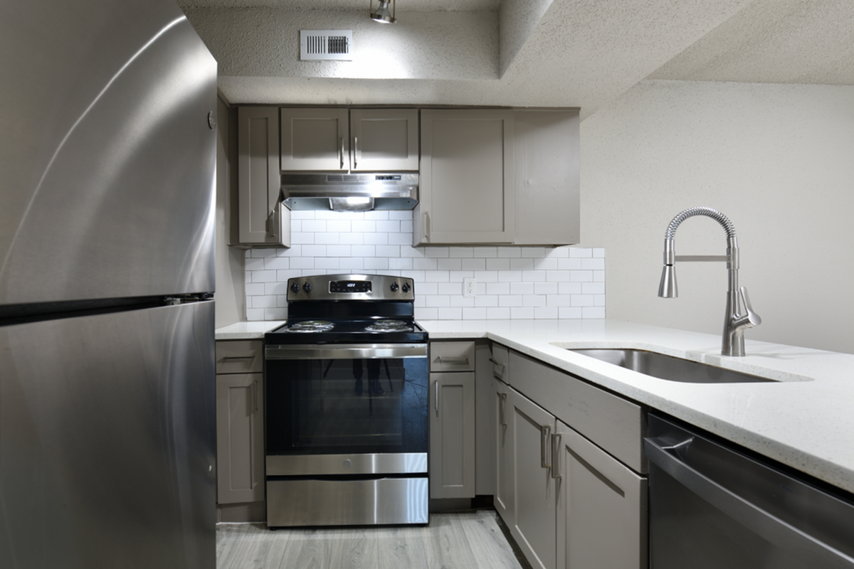 Modern kitchen with sleek stainless steel appliances, elegant cabinetry, and a stylish white subway tile backsplash.
