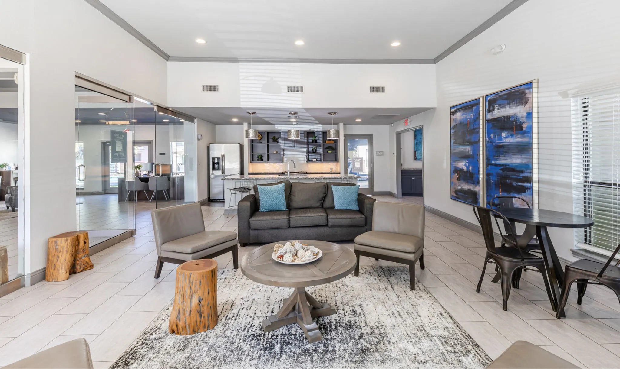 Bright, modern living space featuring an open-concept layout with stylish seating, contemporary decor, and a sleek kitchen with stainless steel appliances.