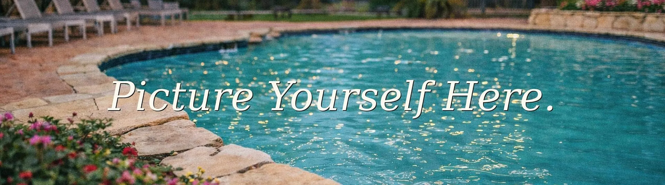 Inviting outdoor pool surrounded by lush greenery and comfortable lounge chairs, perfect for relaxation and leisure.