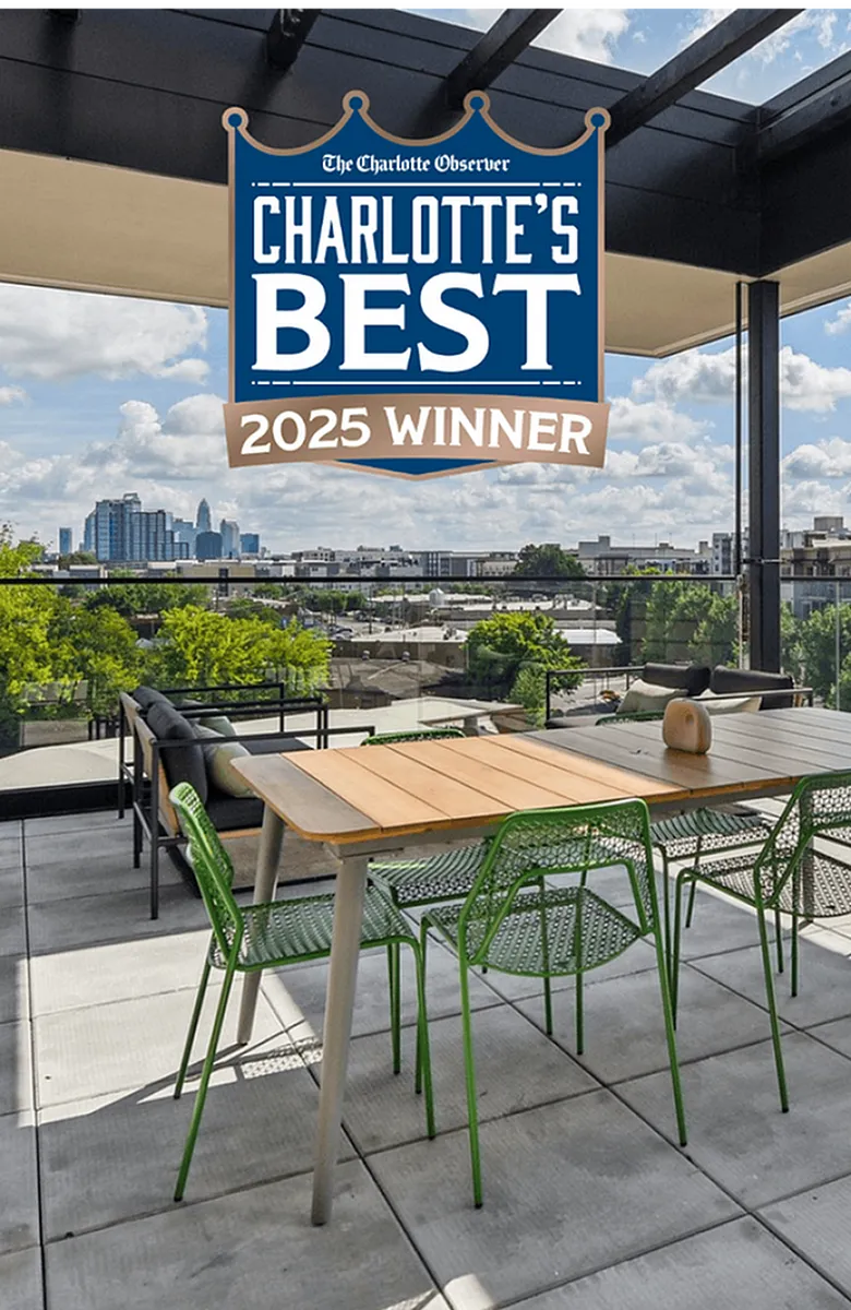 Spacious rooftop patio with stylish seating, offering panoramic skyline views; awarded Charlotte's Best 2025 Winner.