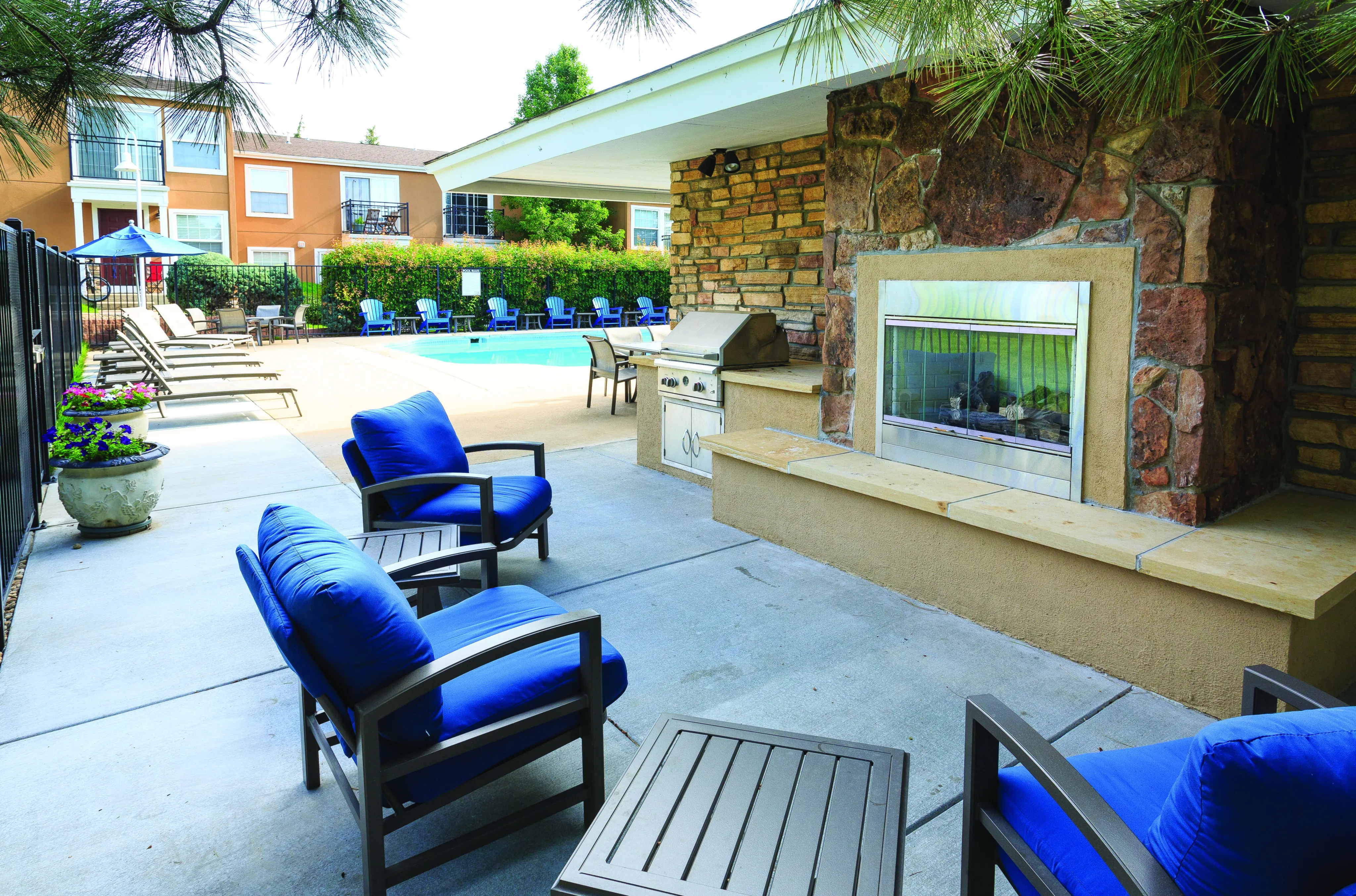 Inviting outdoor area with comfortable seating, a modern grill, and a sparkling swimming pool, perfect for relaxation and entertainment.