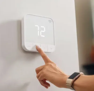 Modern smart thermostat with intuitive touch controls, set at a comfortable 72 degrees.