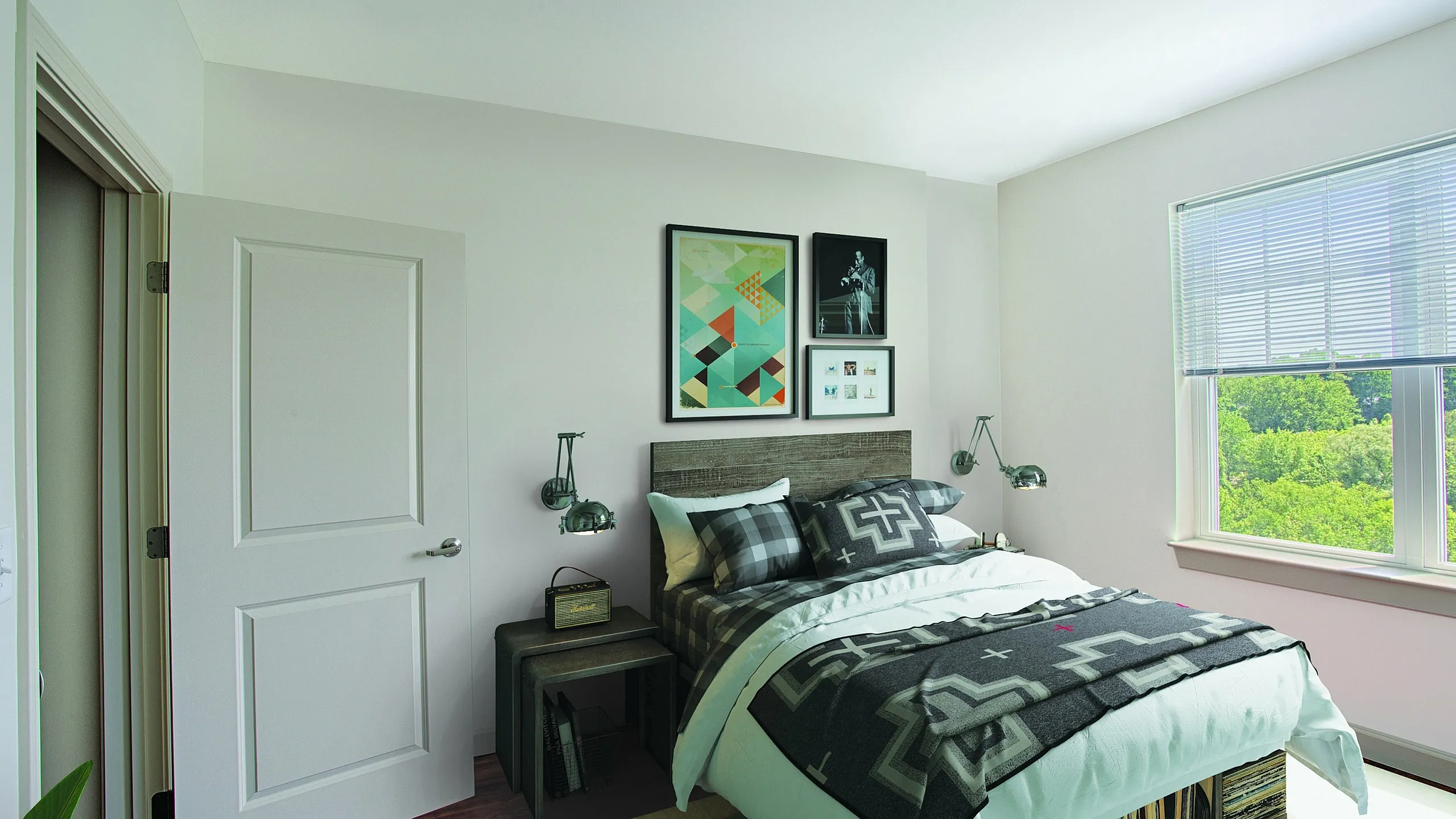 Inviting bedroom with modern decor, featuring a cozy bed, vibrant wall art, and a sunlit window overlooking lush greenery.