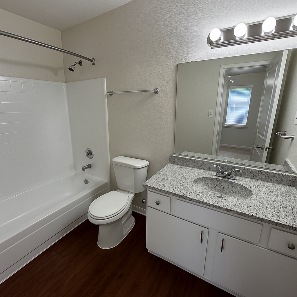Bright and modern bathroom featuring sleek countertop, large mirror.