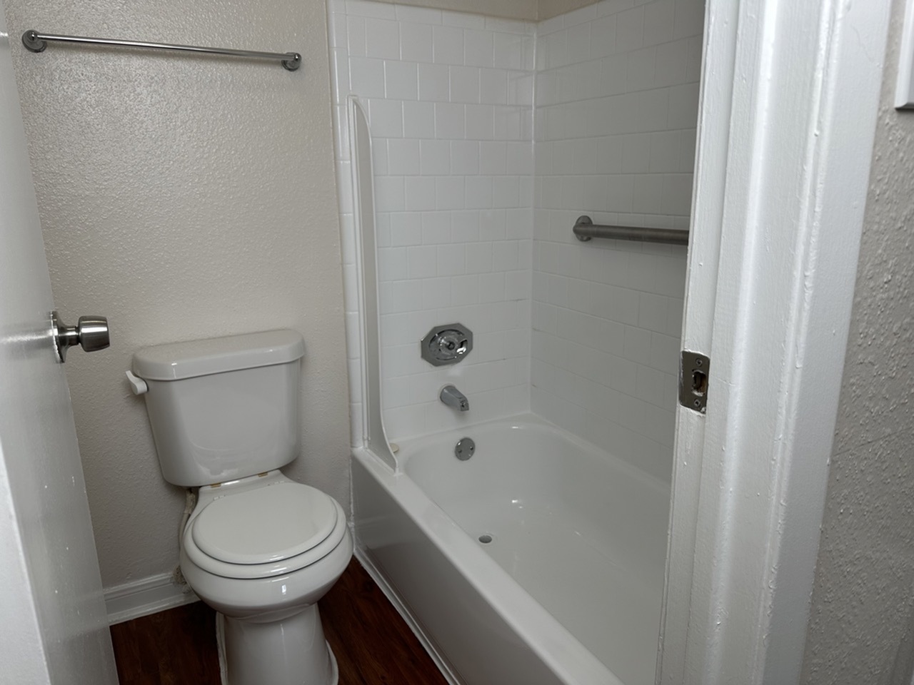 Modern bathroom with a sleek bathtub and pristine white tiles creating a fresh and clean atmosphere.