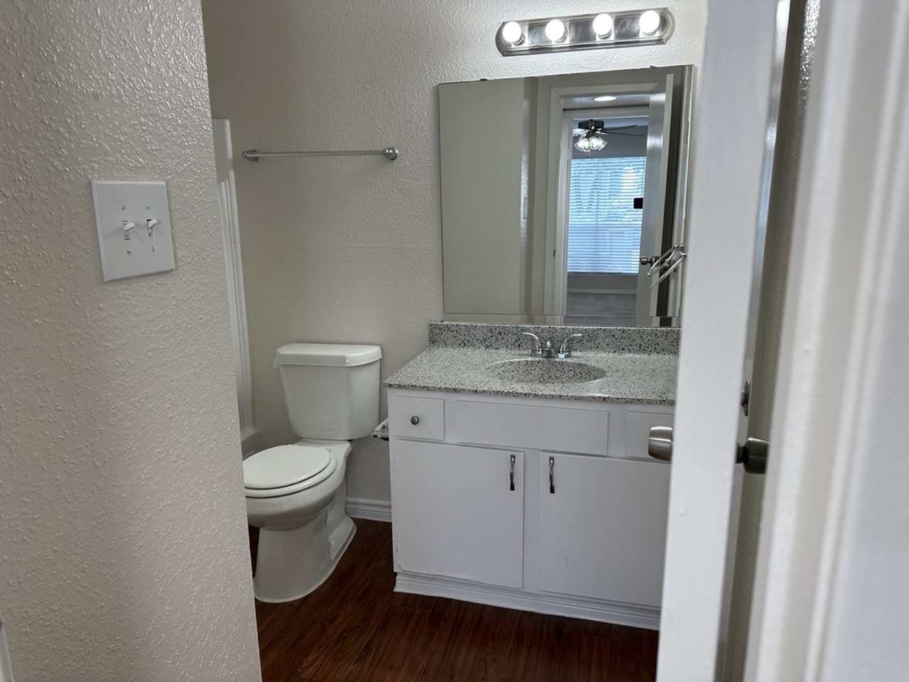 Modern bathroom with pristine vanity, sleek countertop, and elegant lighting, perfect for a refreshing start to your day.