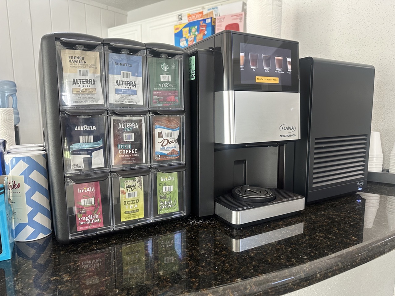 Modern beverage station featuring a sleek coffee machine with a variety of flavors for a personalized brew experience.