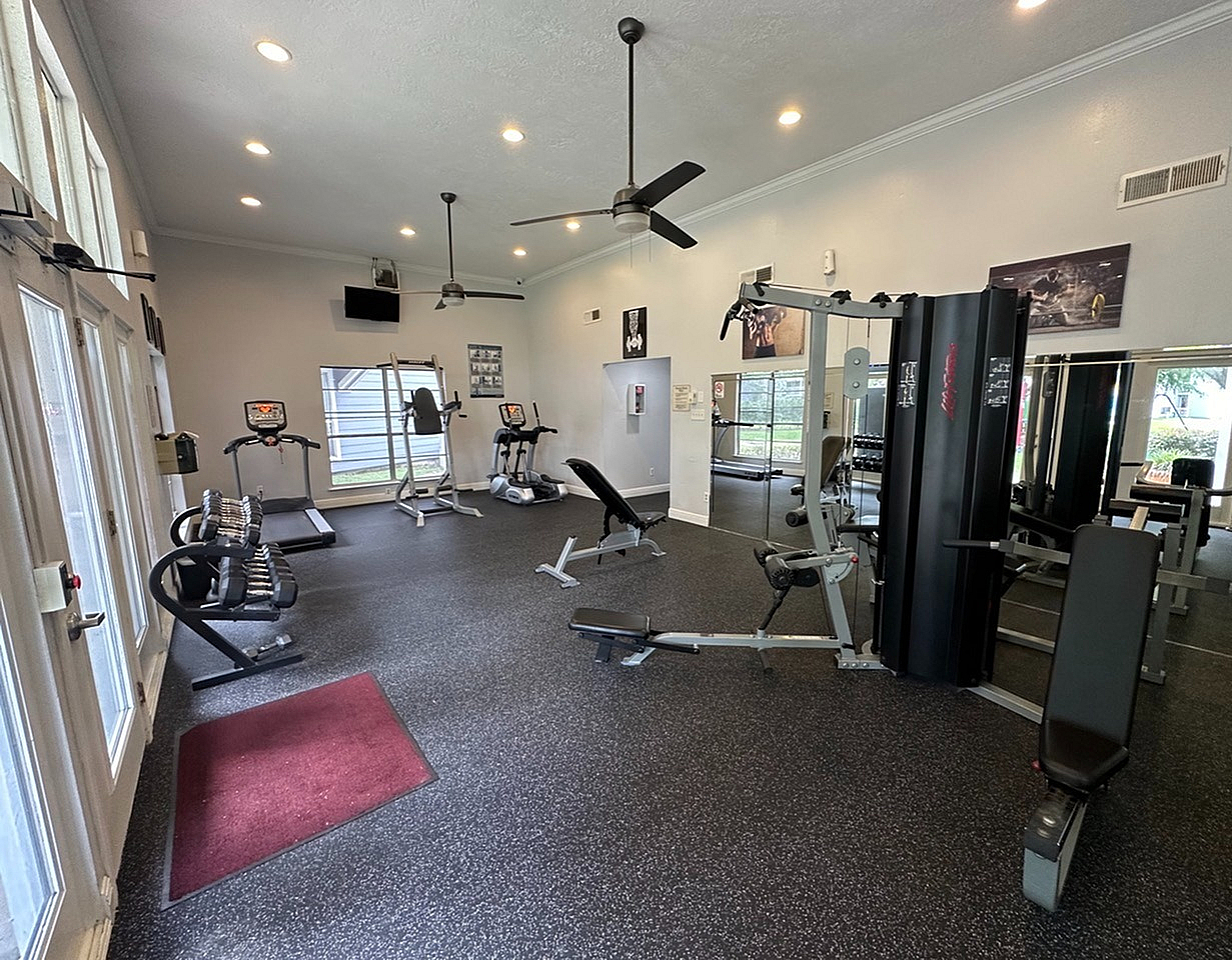 Modern fitness center with state-of-the-art equipment, bright lighting, and spacious workout areas, perfect for an invigorating exercise session.