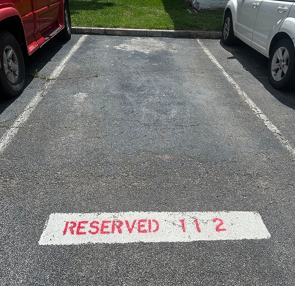 Convenient reserved parking space marked \'RESERVED 112\', perfect for easy access and peace of mind.