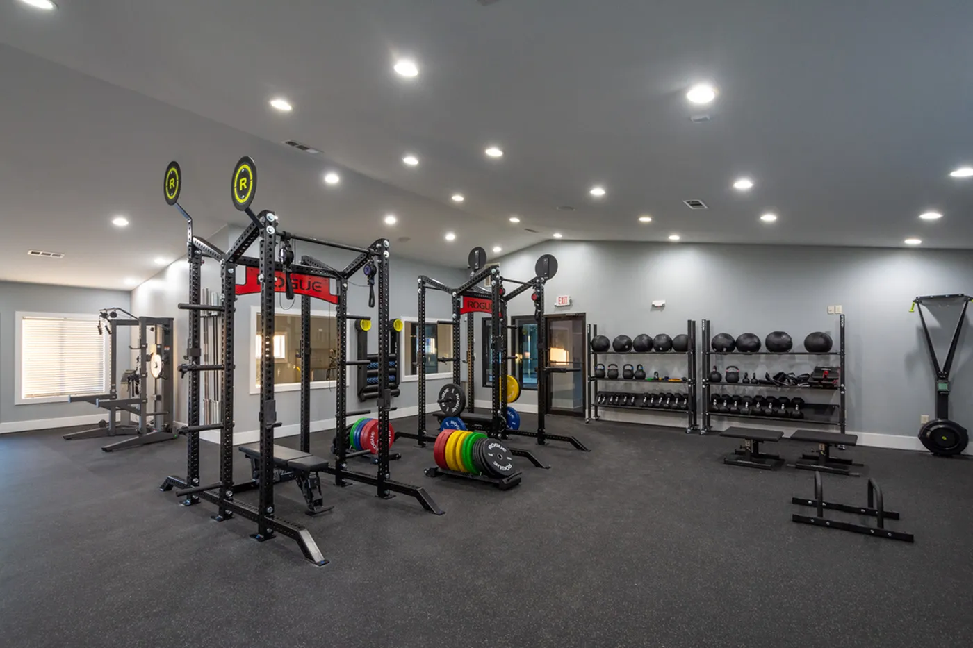 Spacious, modern fitness center featuring state-of-the-art exercise equipment and ample natural light.