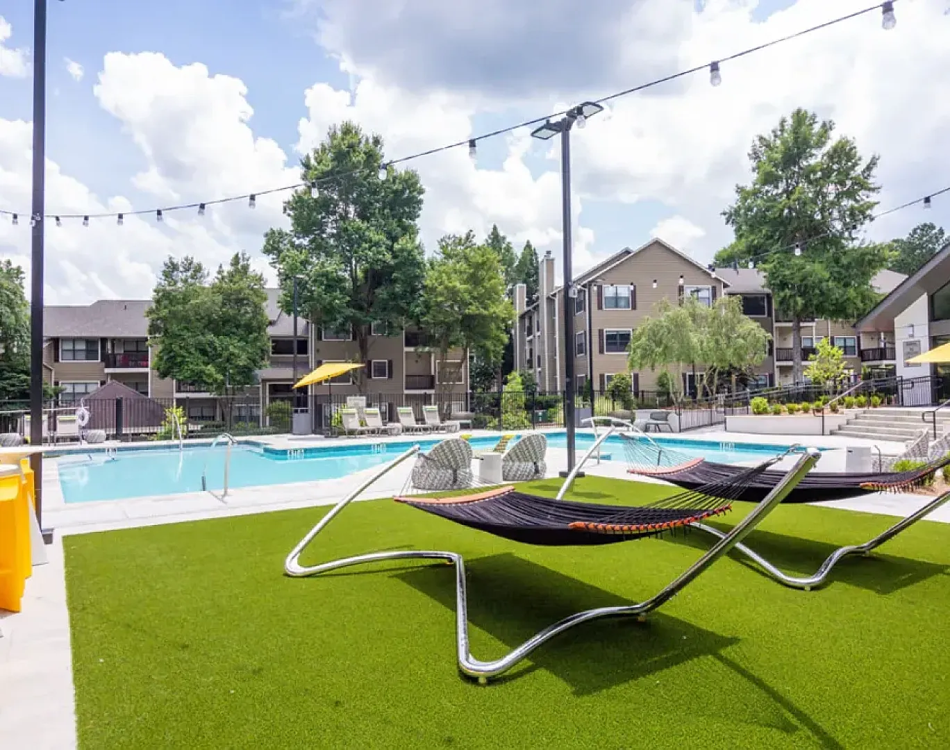 2 hammocks over a beautiful pool on a sunny day
