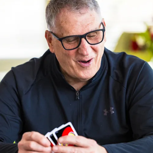 Man playing cards in The Commons of Redbud Commons