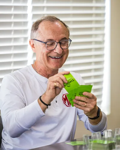 Man smiling and playing cards