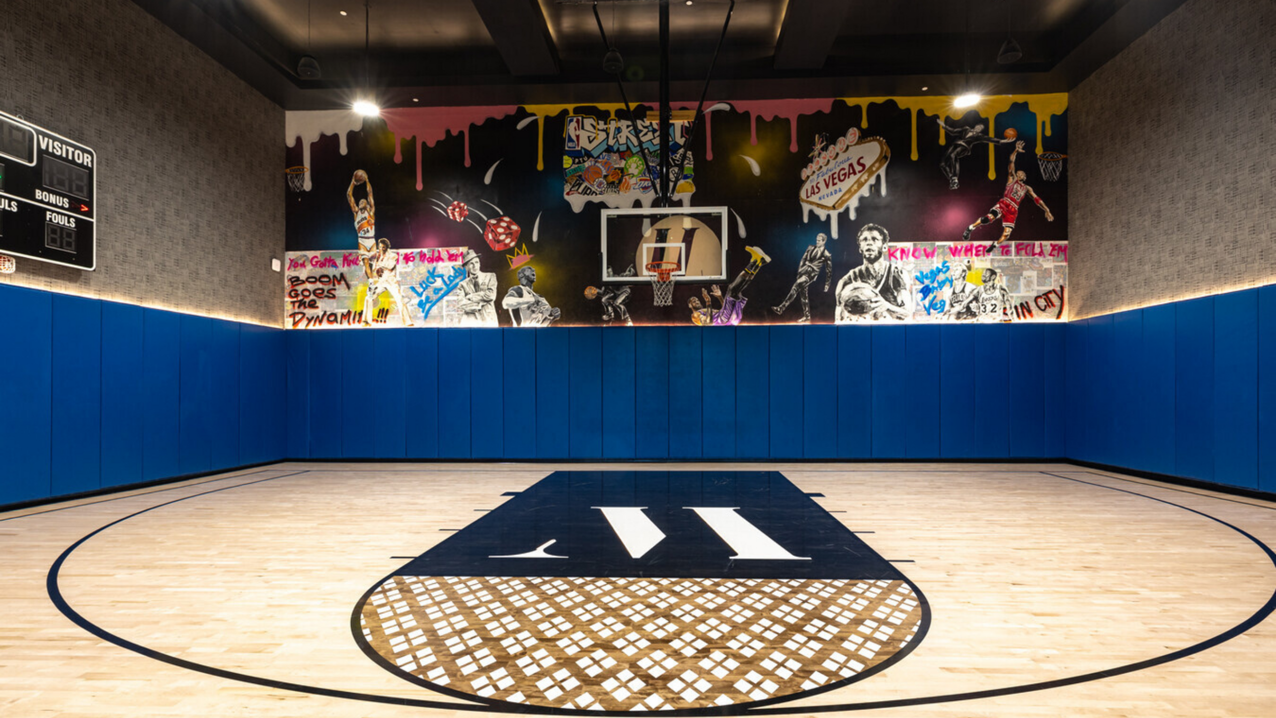 Vibrant indoor basketball court with artistic mural, perfect for sports enthusiasts and modern living.
