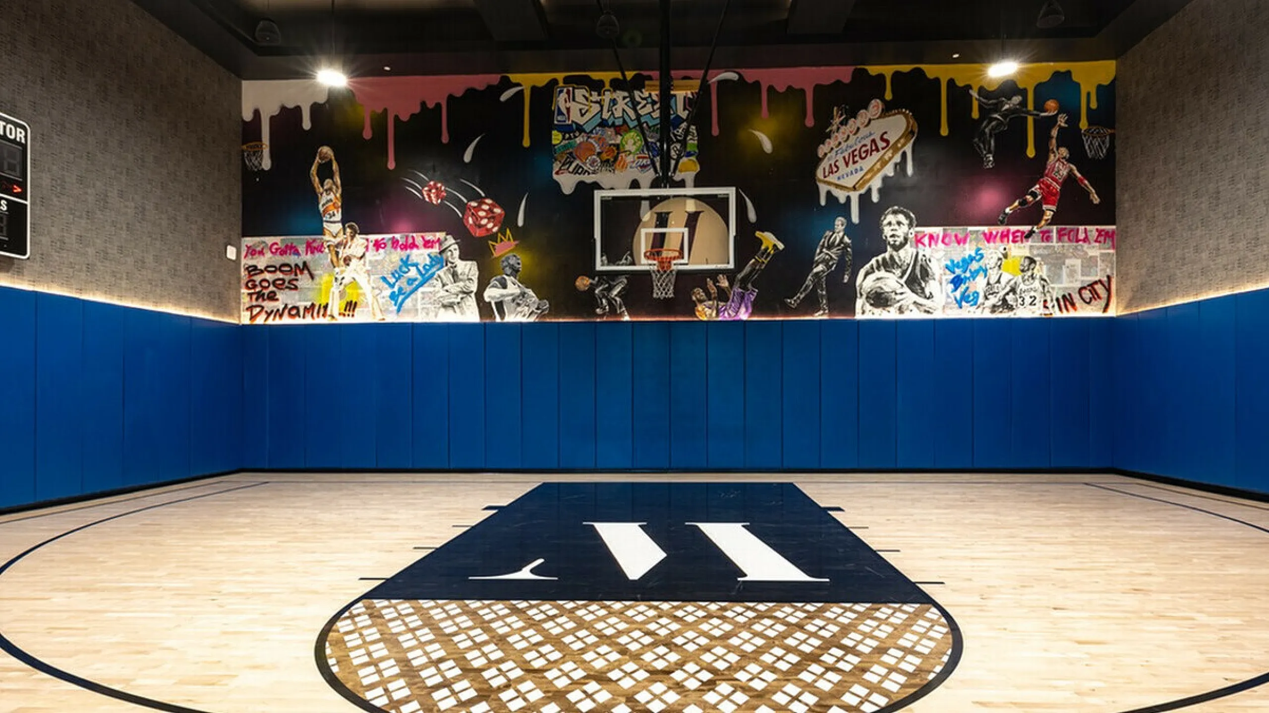 Vibrant indoor basketball court with colorful graffiti art and modern design elements.