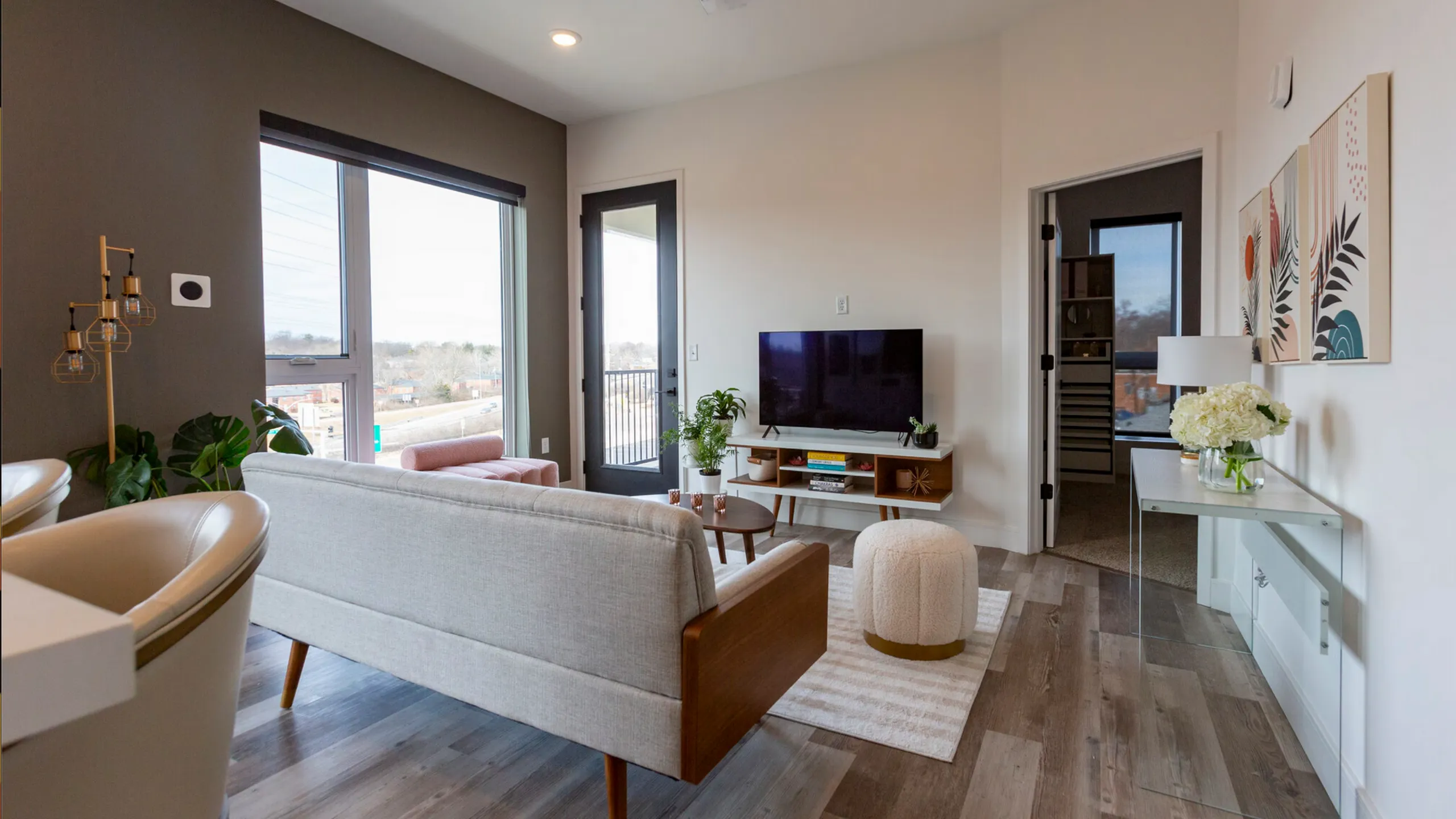 Modern living area with sleek furniture, large windows, and chic decor offering a welcoming and stylish atmosphere.