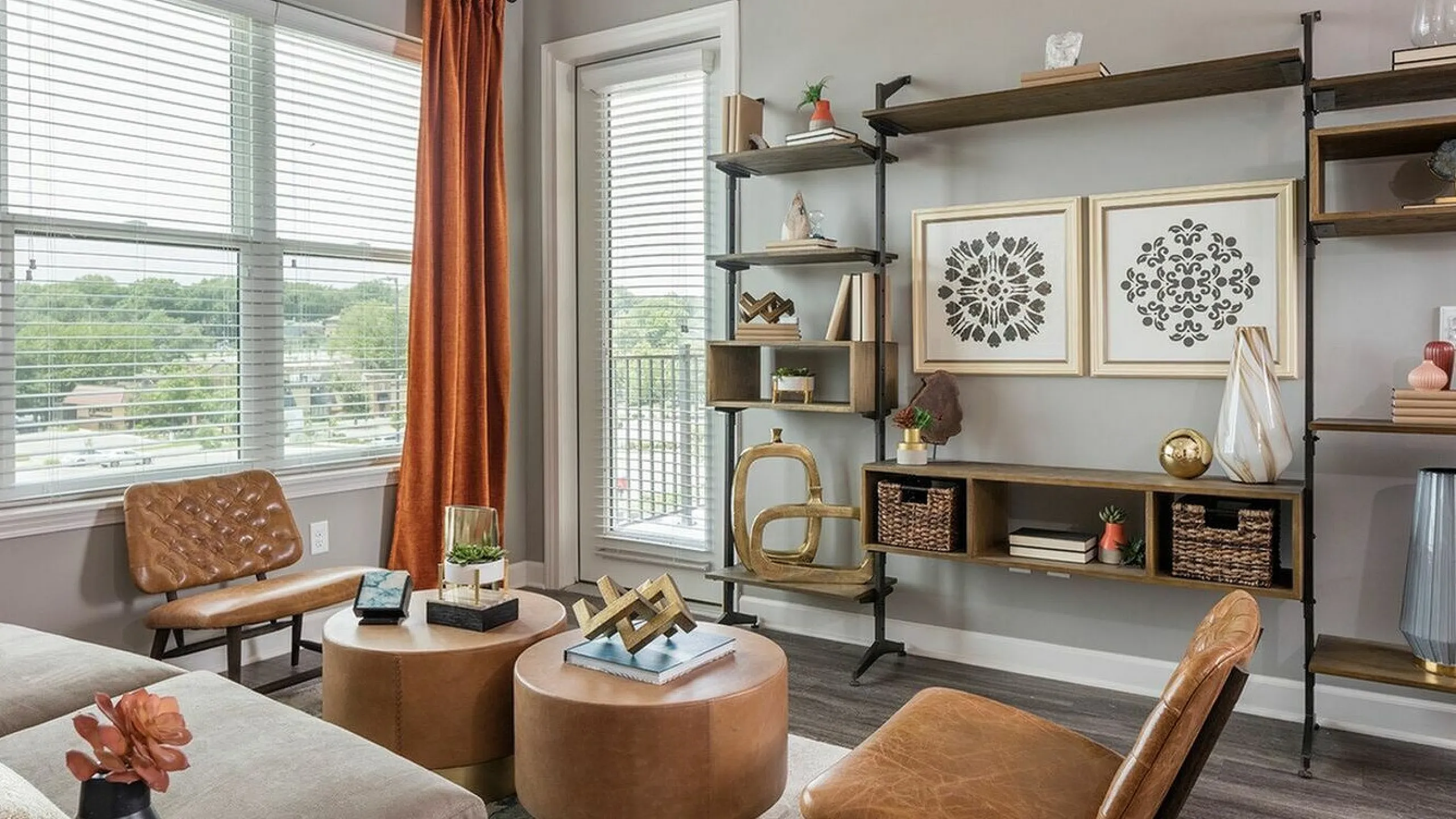 Chic living room with modern decor, featuring cozy leather chairs, stylish wall art, and vibrant natural light enhancing the contemporary shelving.