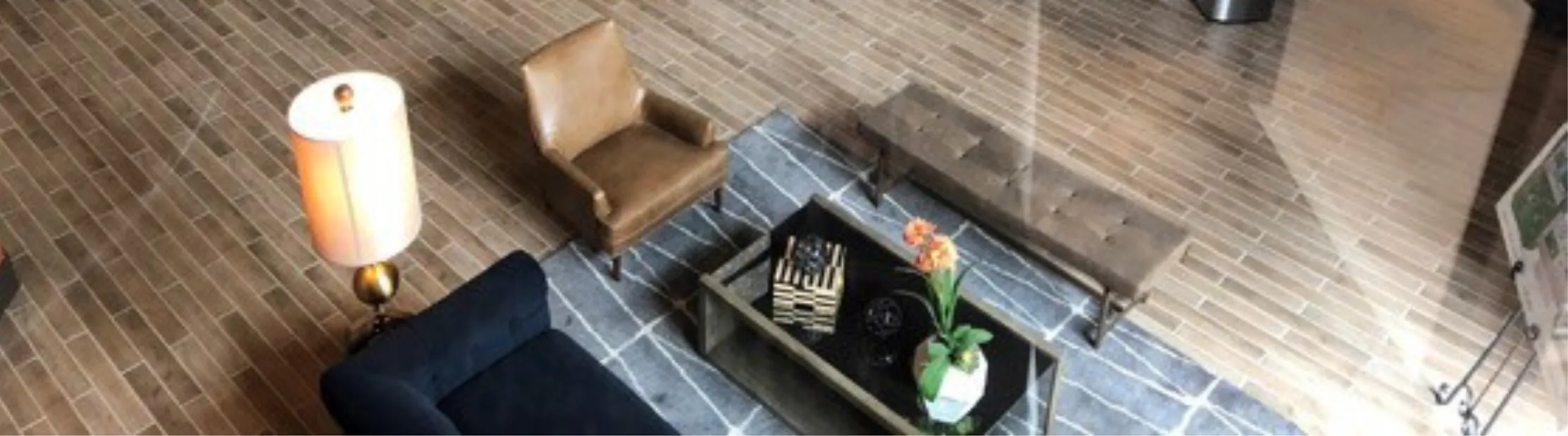 Elegant modern living area with plush seating, stylish lighting, and chic decor on sleek tiled flooring.